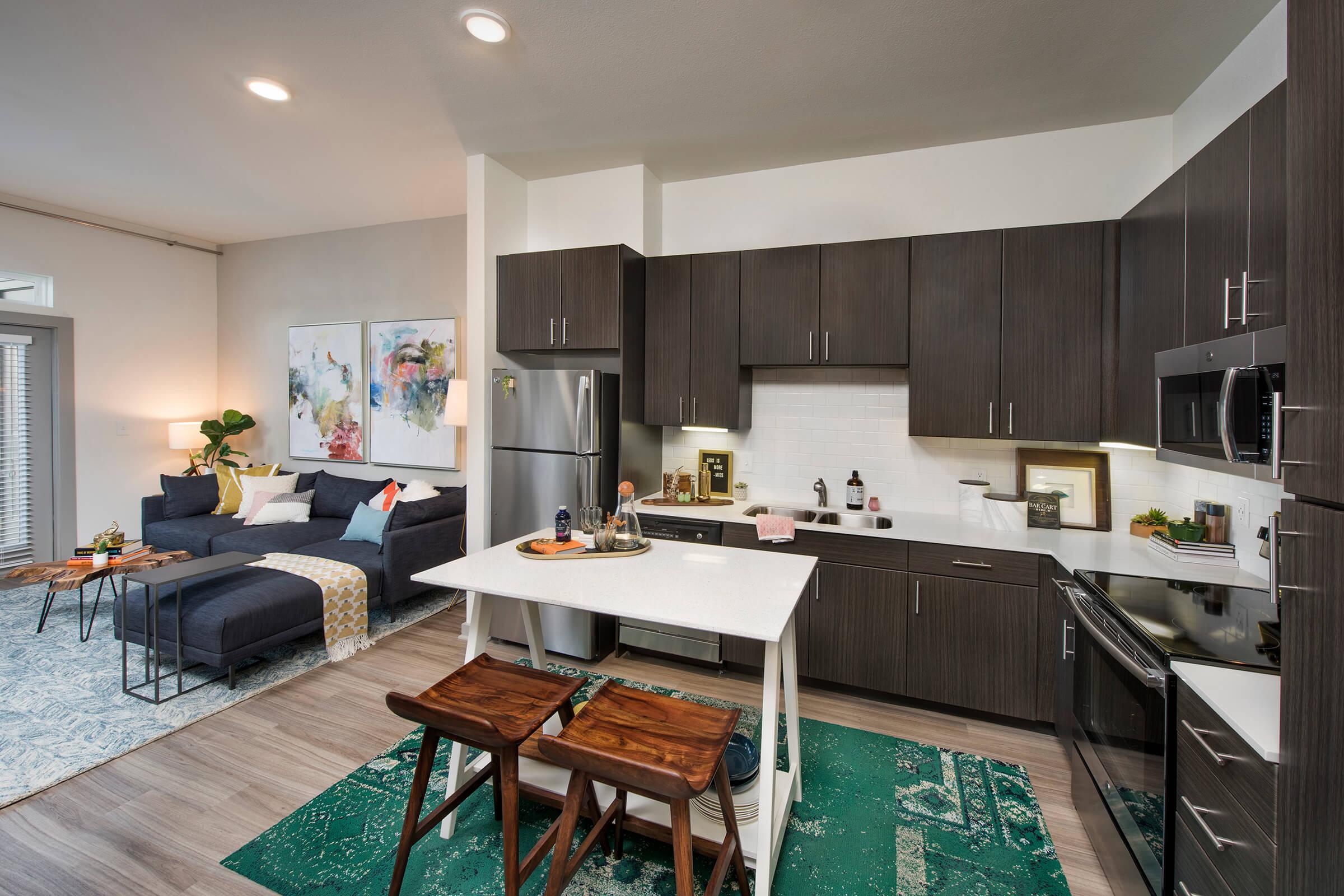 a kitchen with an island in the middle of a room