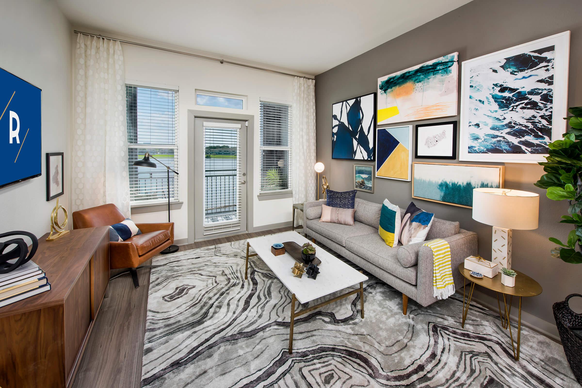 a living room filled with furniture and a large window
