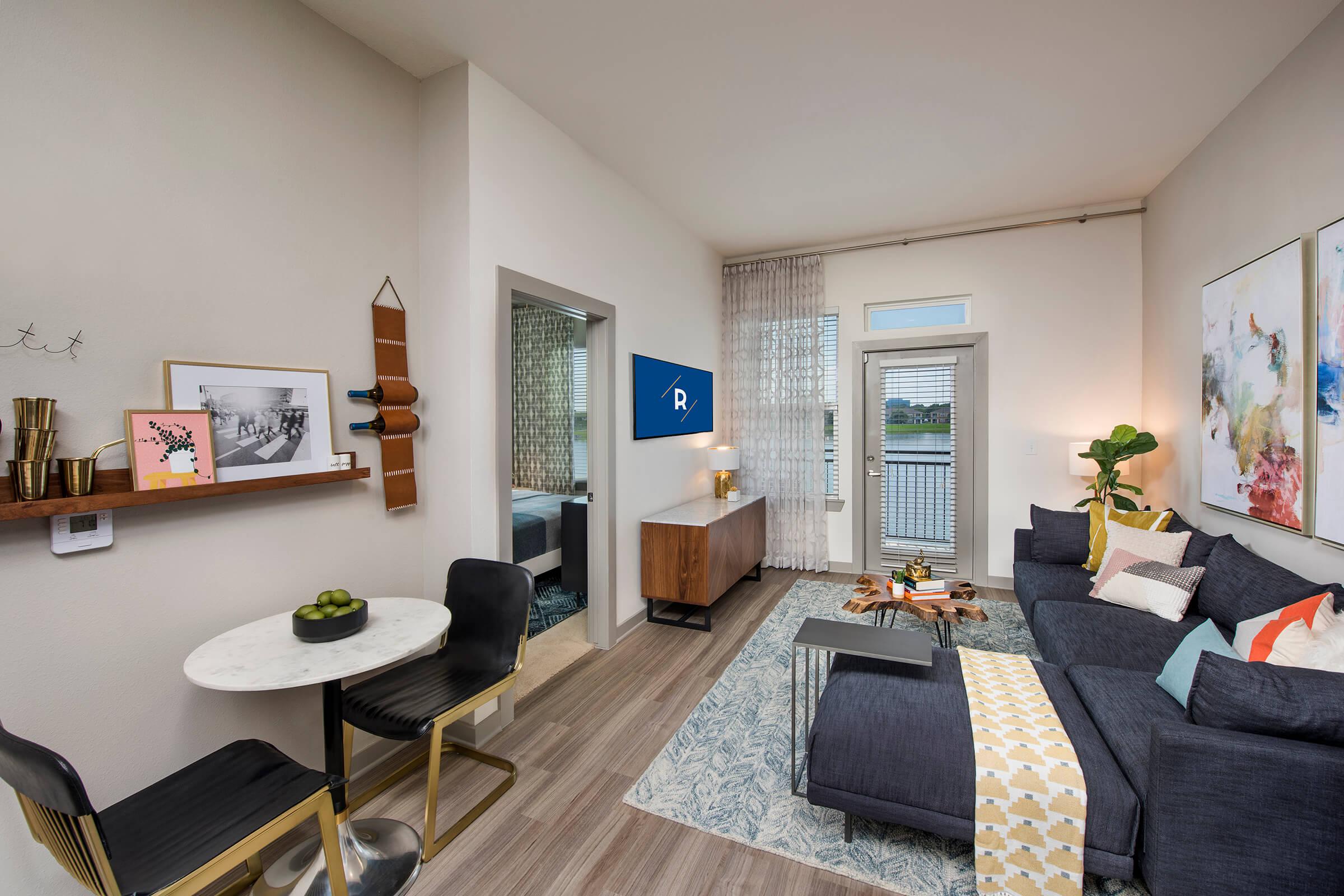 a living room filled with furniture and a large window