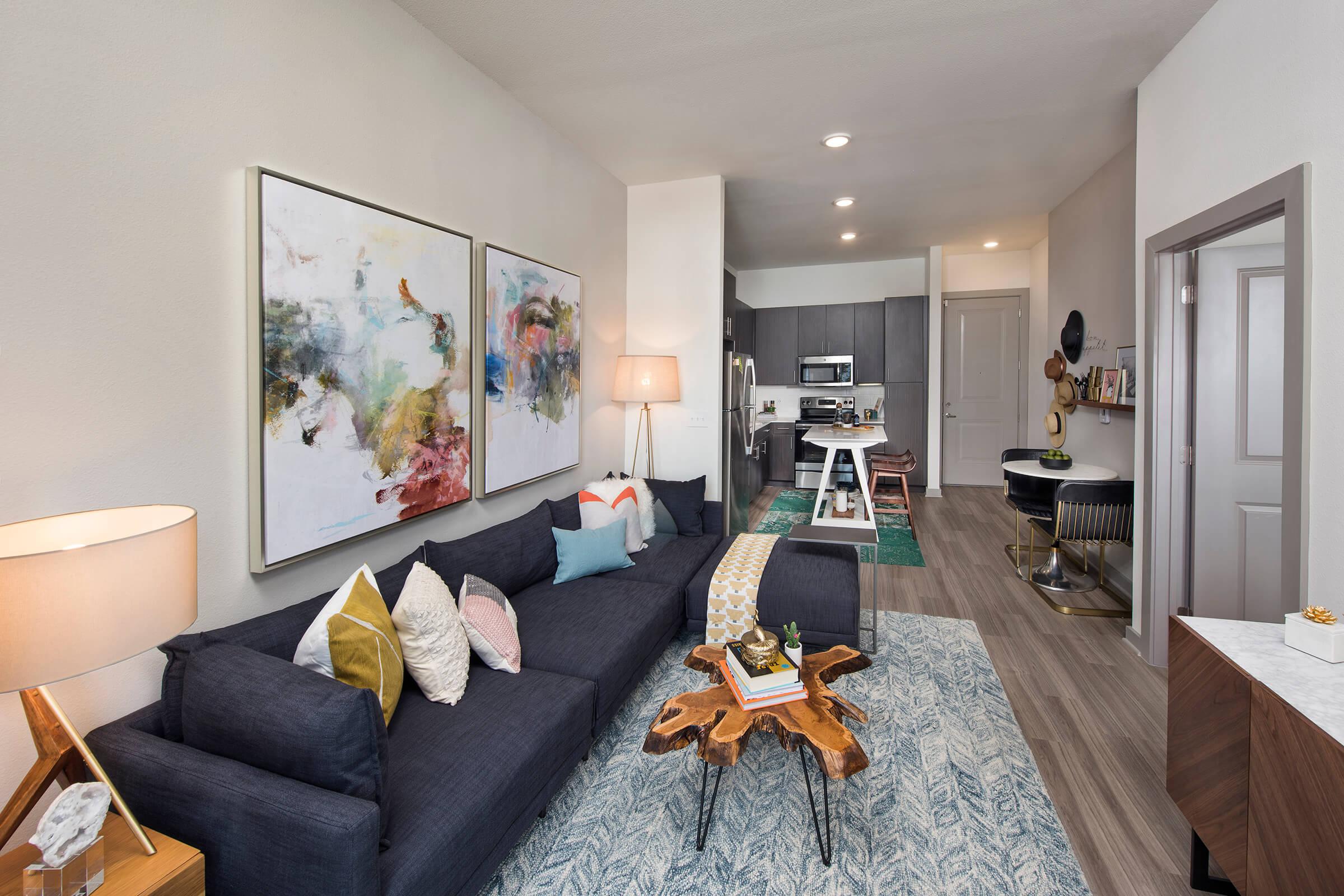 a living room filled with furniture and a bed