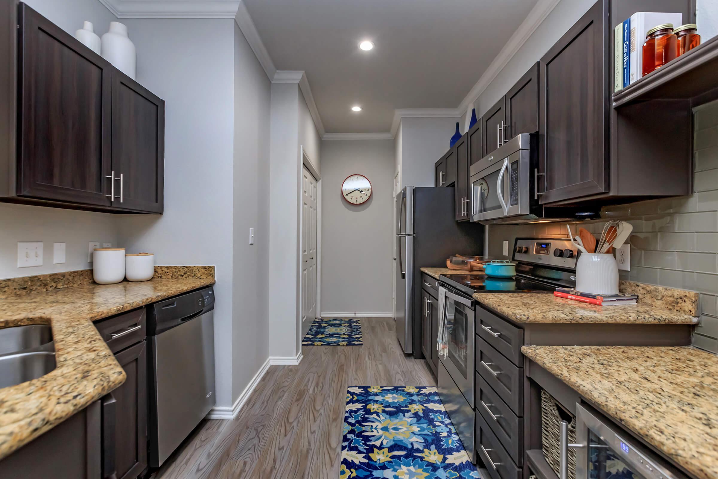 a kitchen with a sink and a mirror