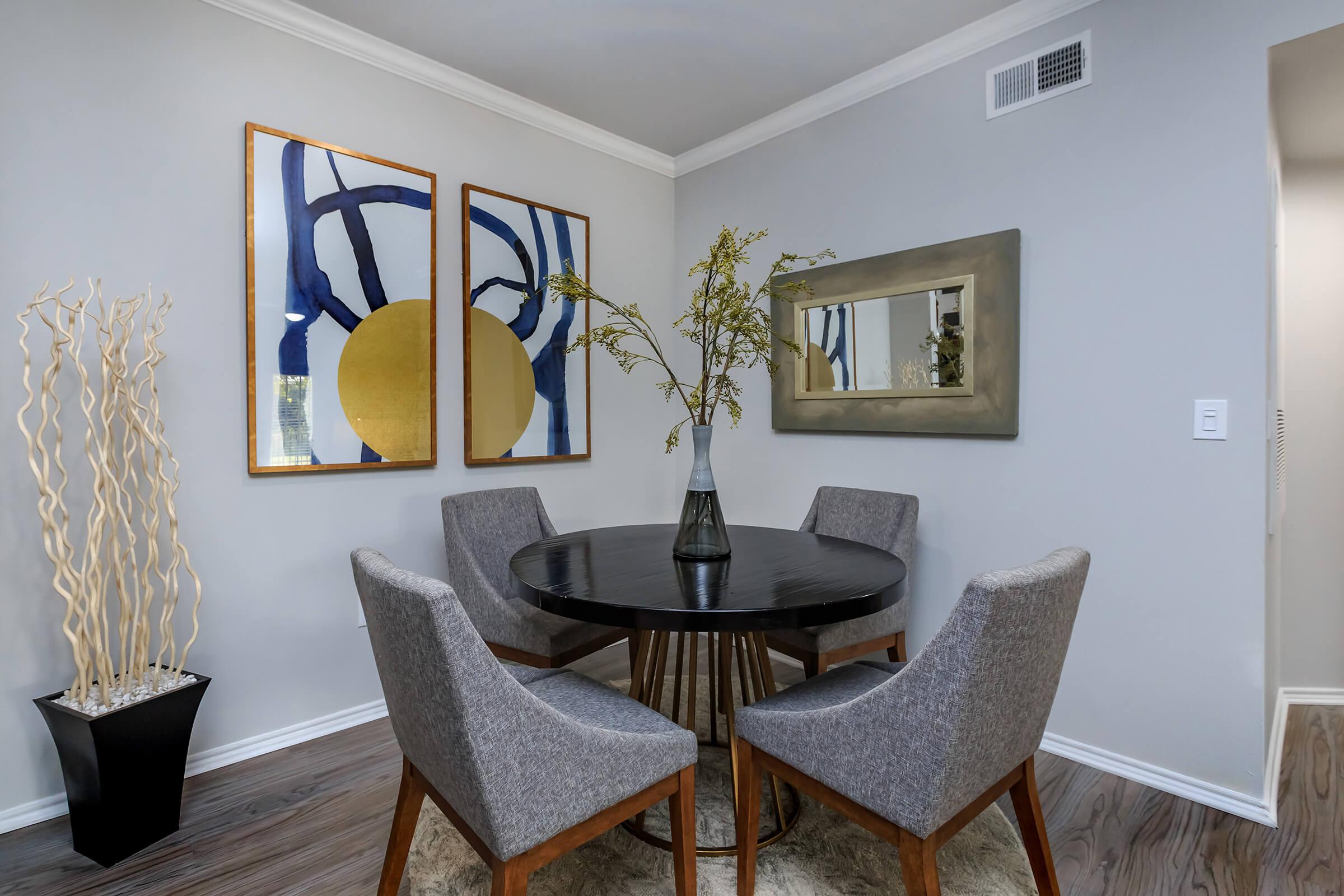 a room filled with furniture and vase on a table