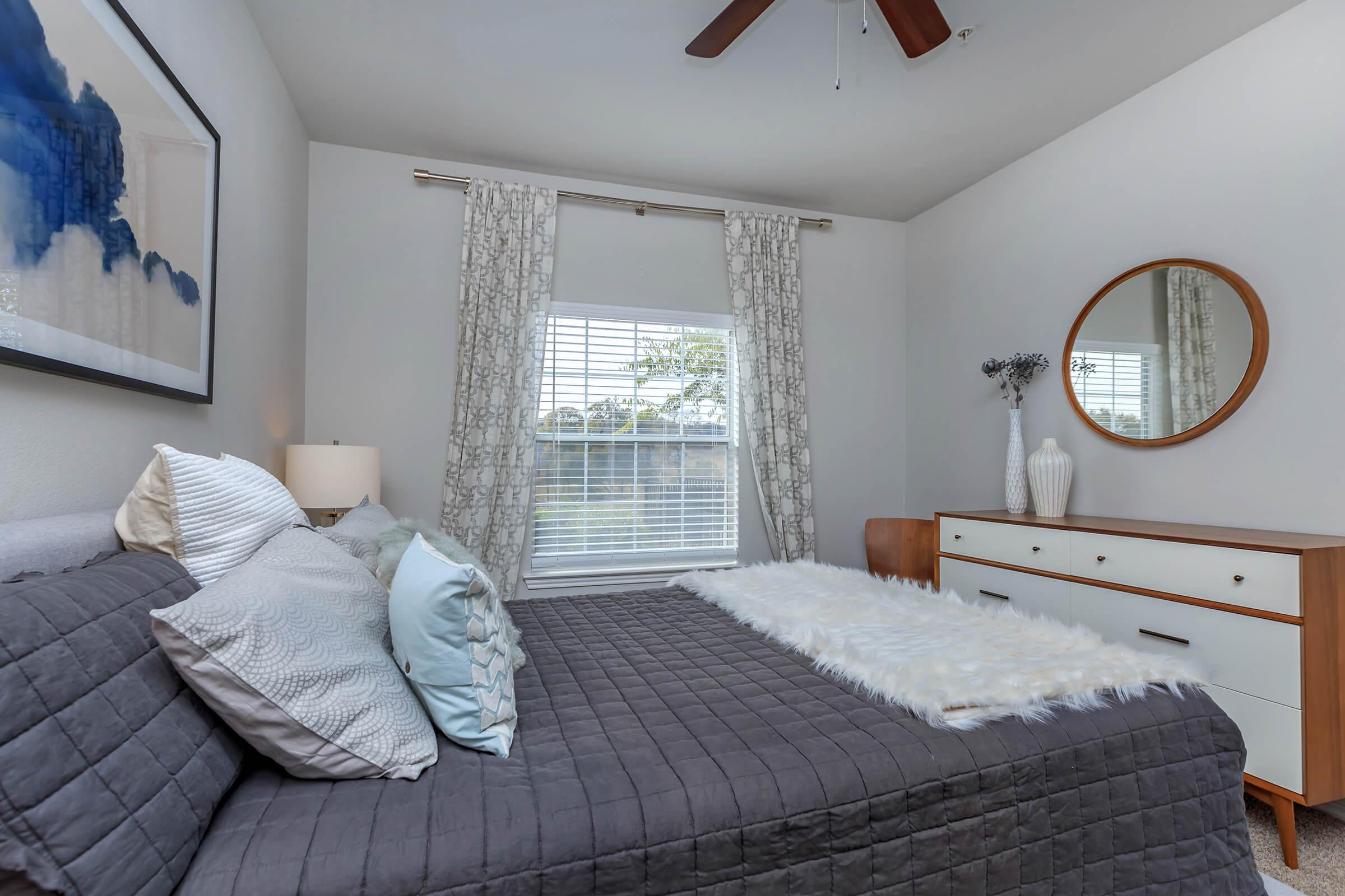 a bedroom with a bed in a room