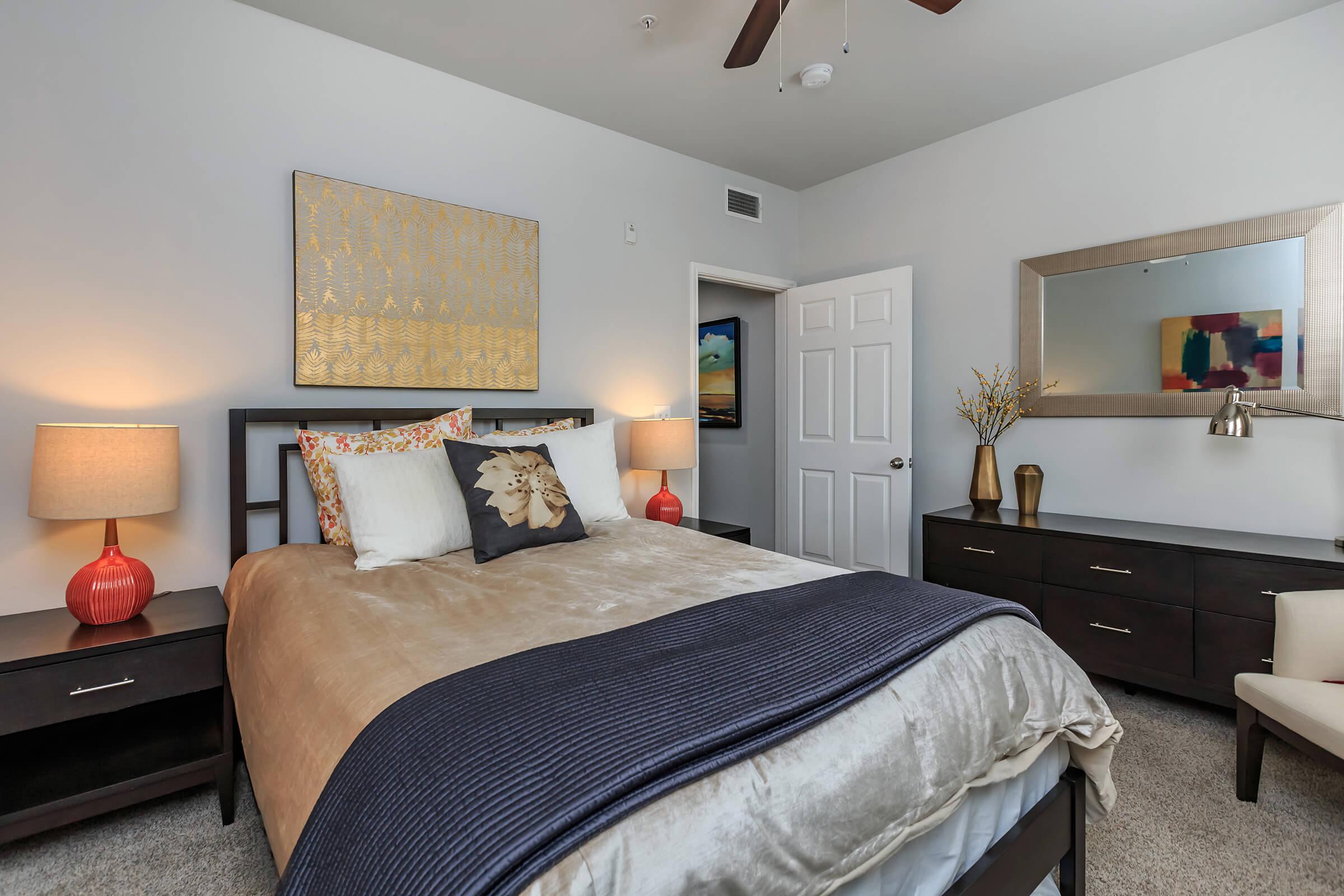 a bedroom with a bed and desk in a room