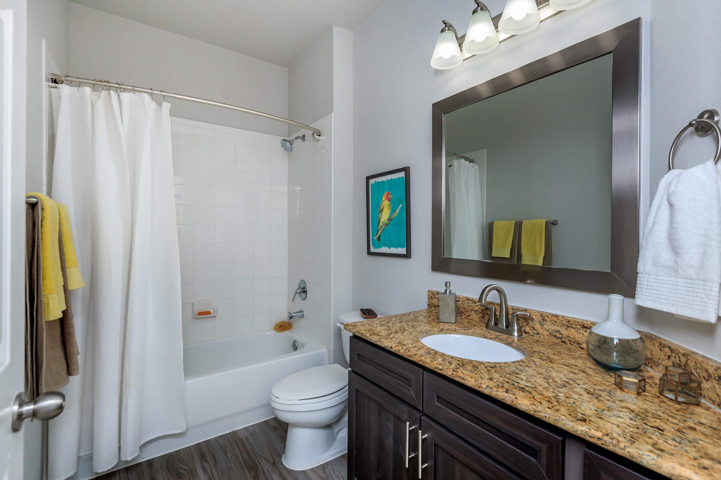 a white sink and a mirror