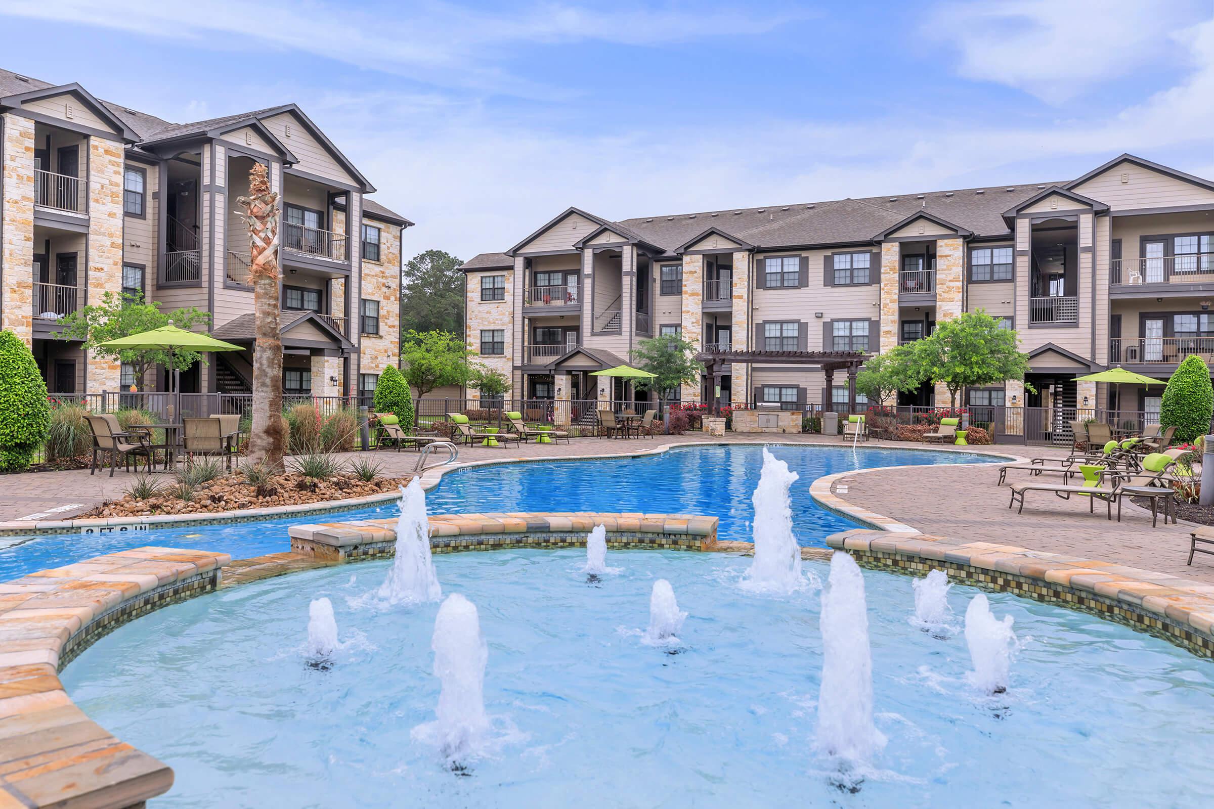 a flock of seagulls in a pool of water in front of a house