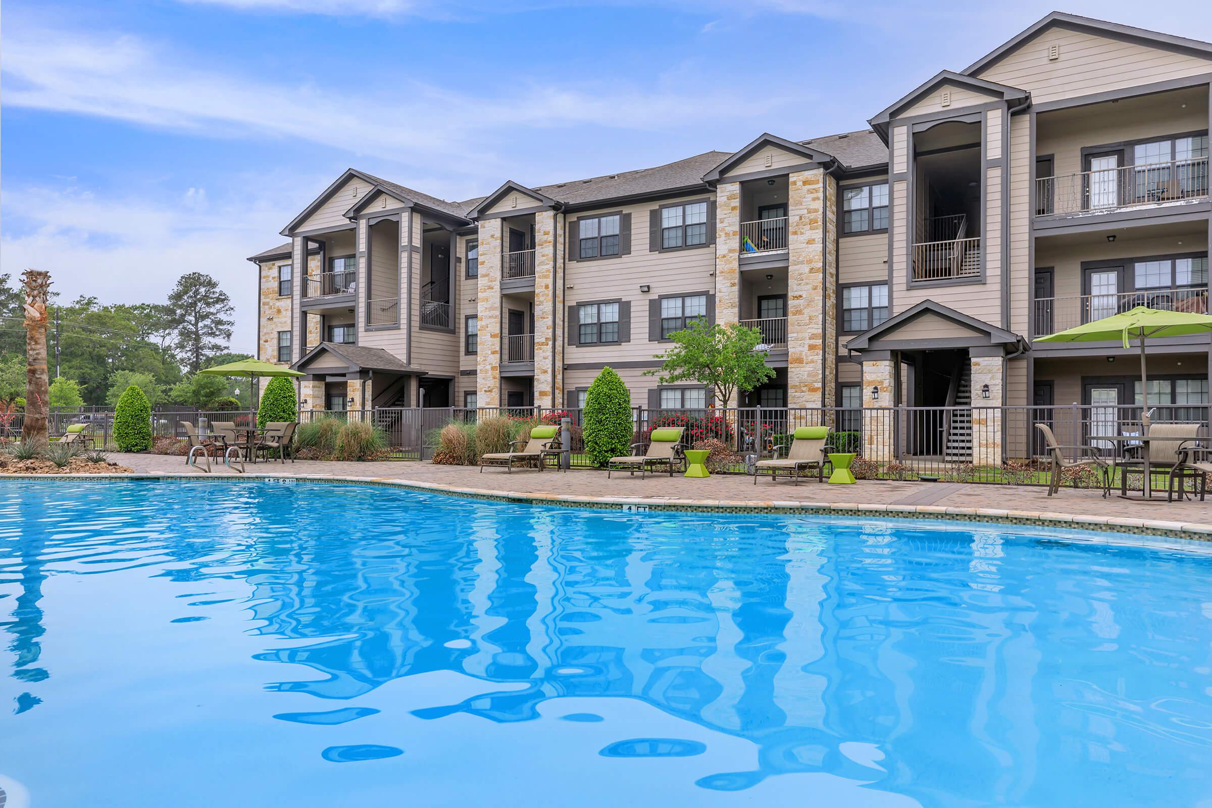 a large pool of water in front of a house