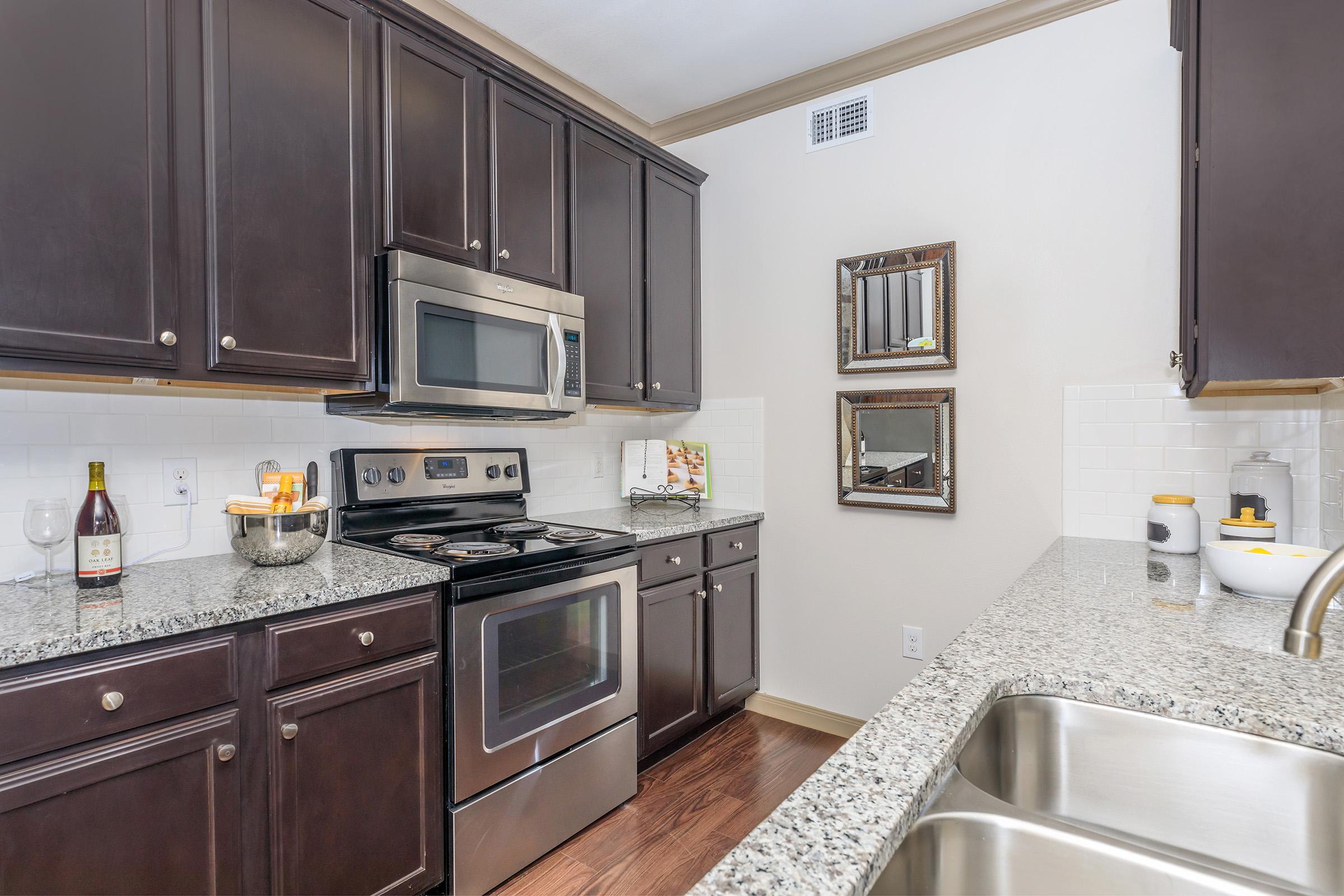 a kitchen with stainless steel appliances and wooden cabinets