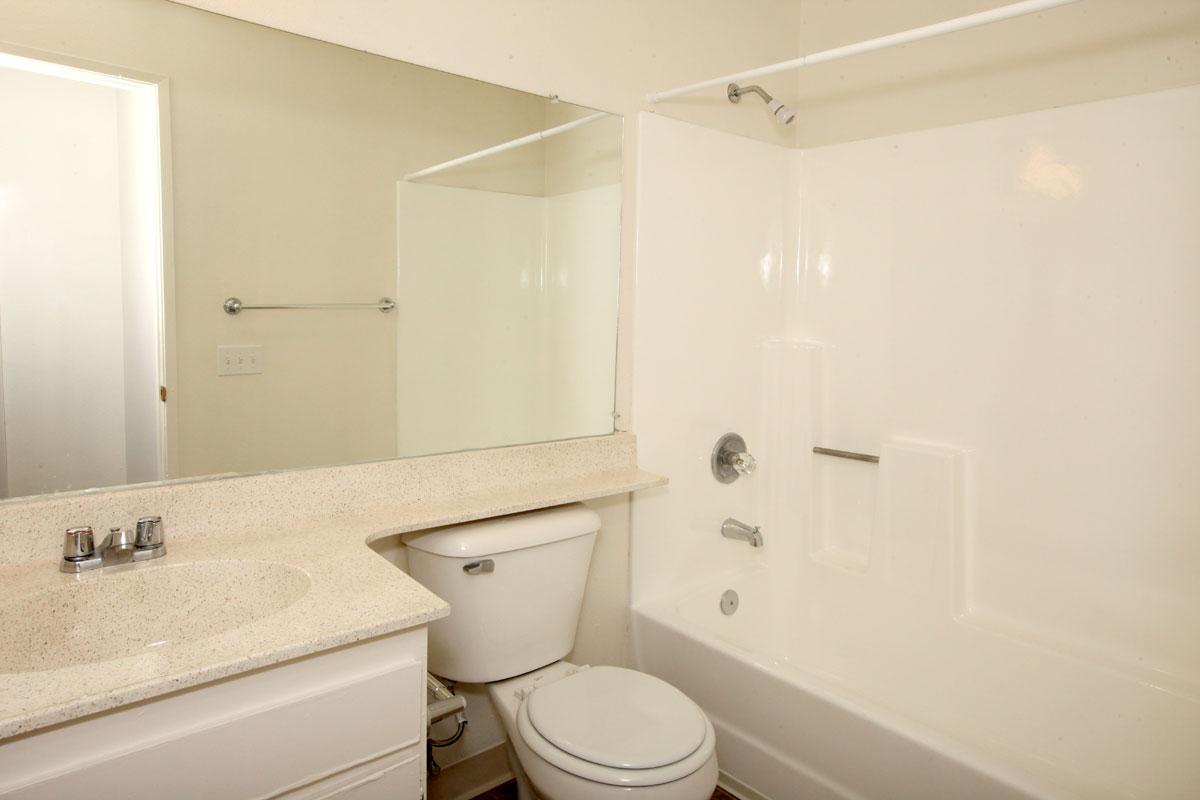 a white tub sitting next to a shower