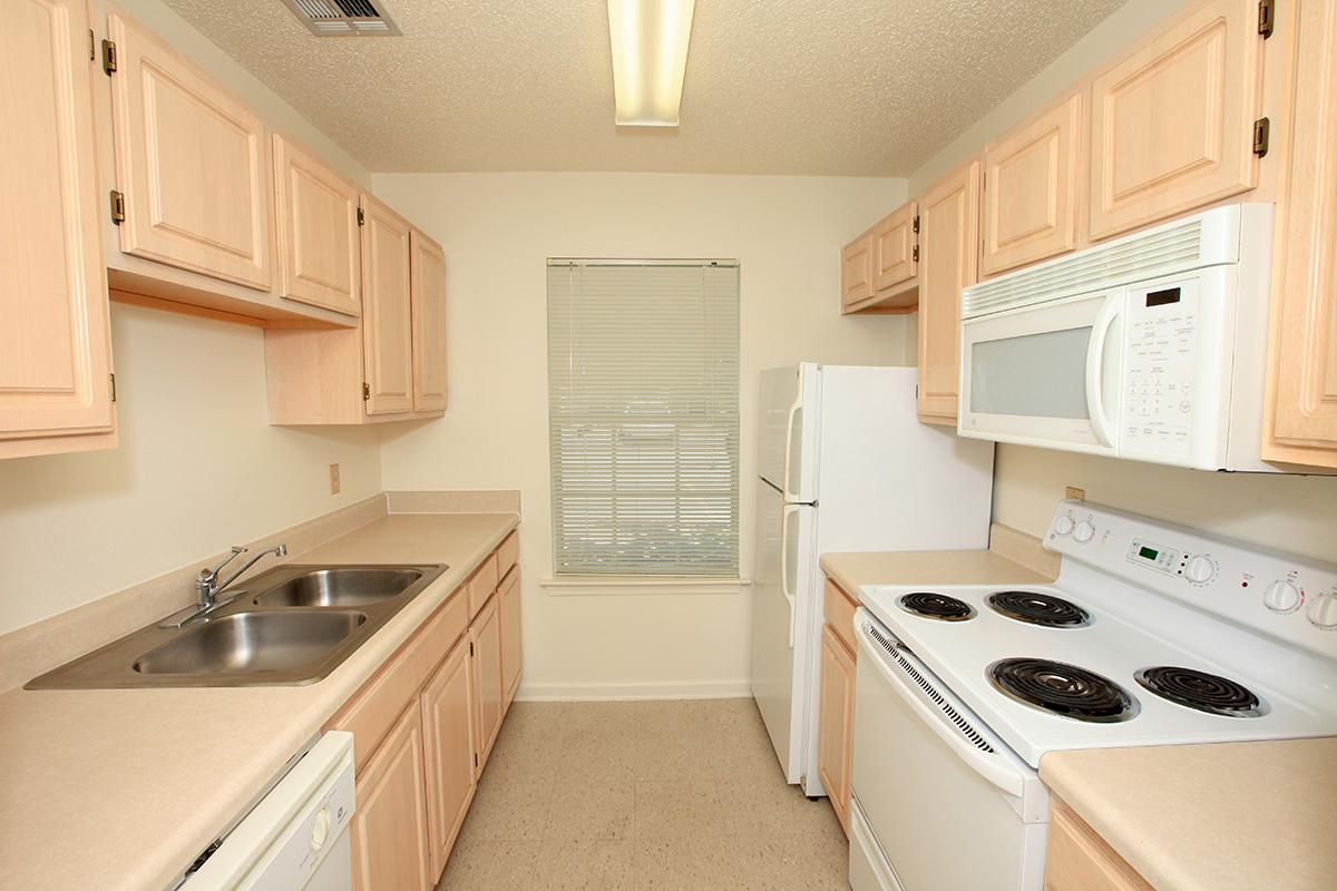 a white stove top oven sitting inside of a kitchen