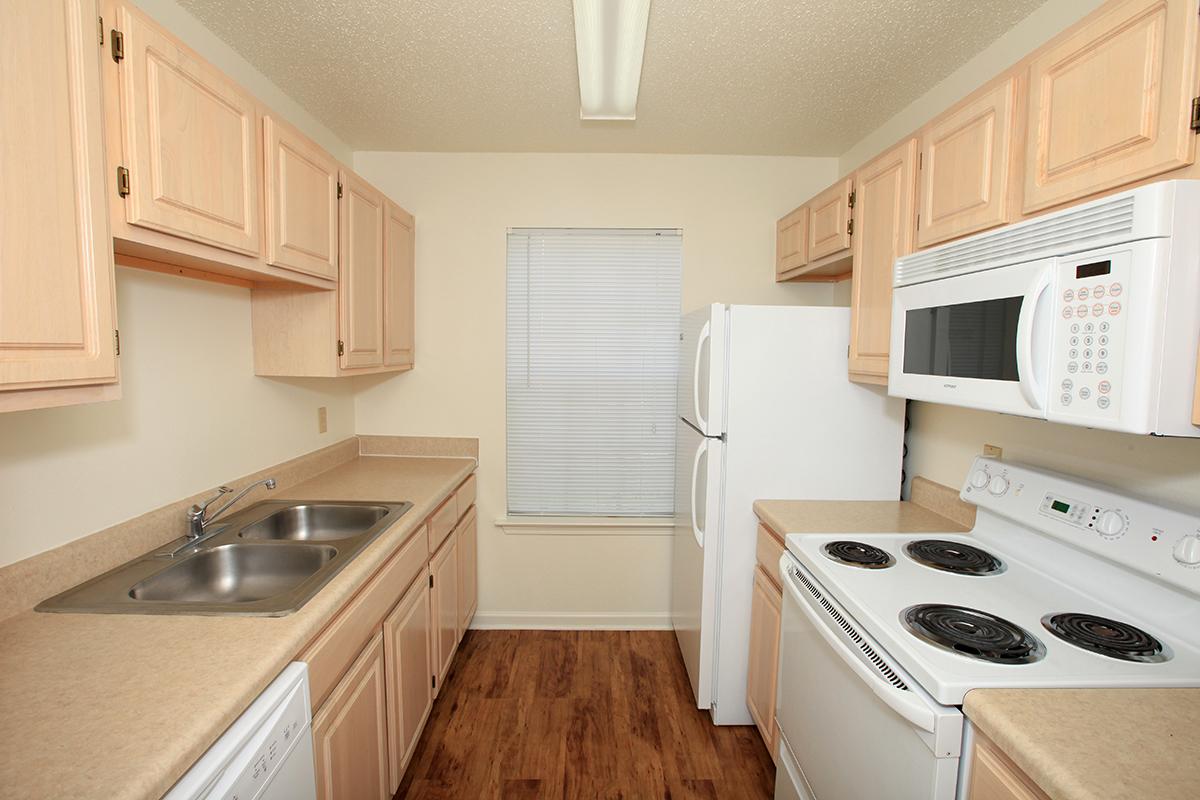 a white stove top oven sitting inside of a kitchen