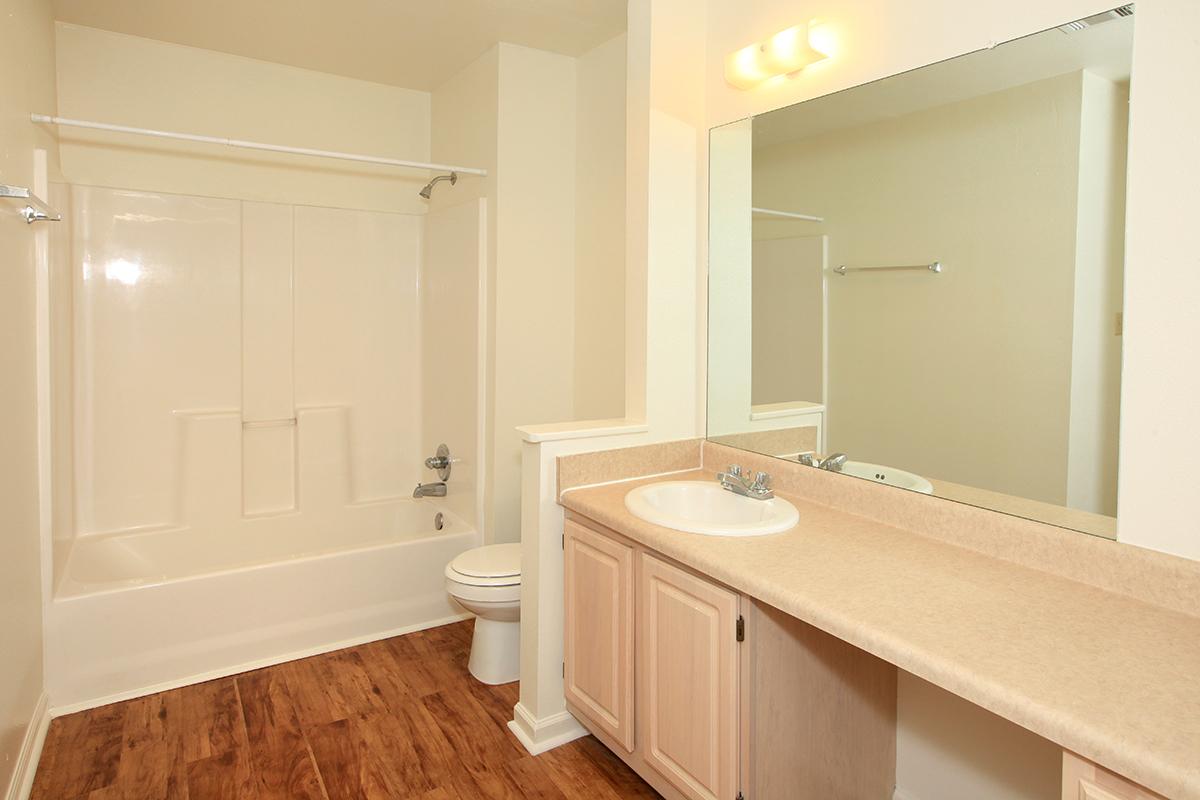 a large white tub next to a sink
