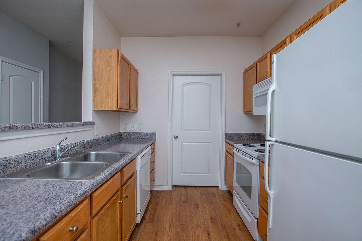 a kitchen with a stove and a refrigerator