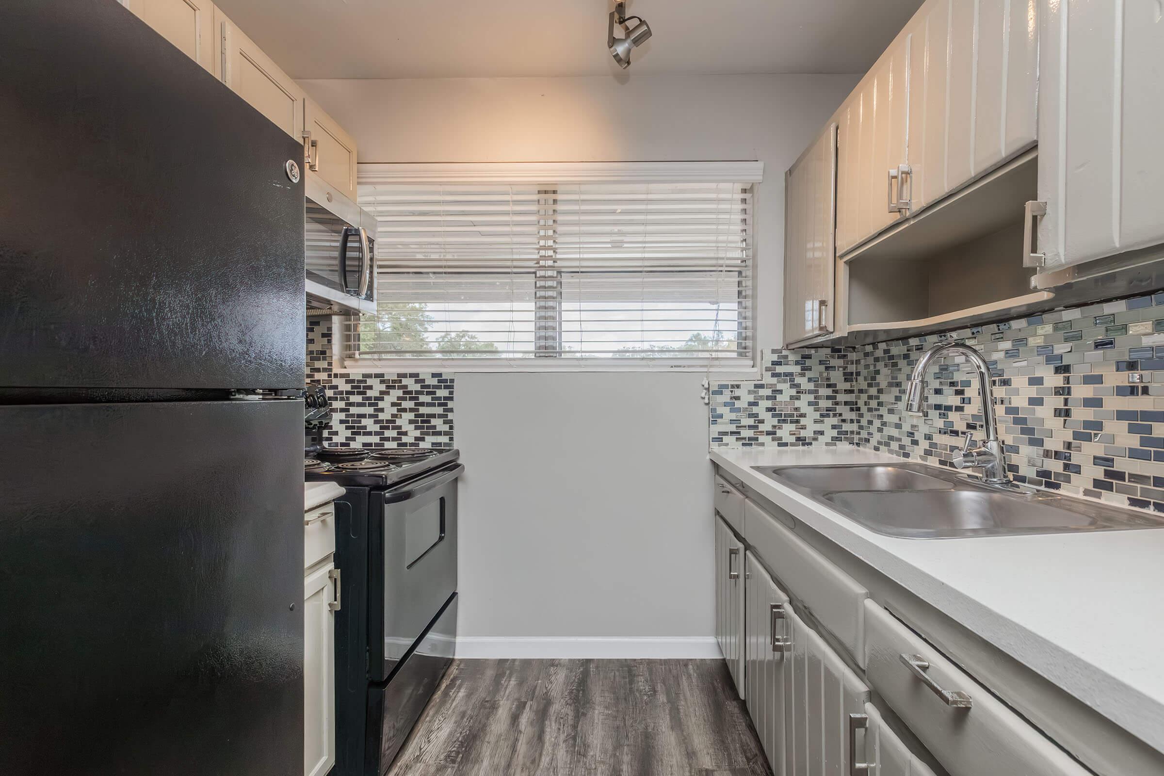 a kitchen with a stove and a refrigerator