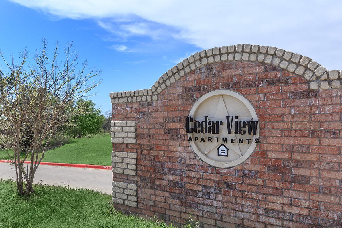 a sign in front of a brick building