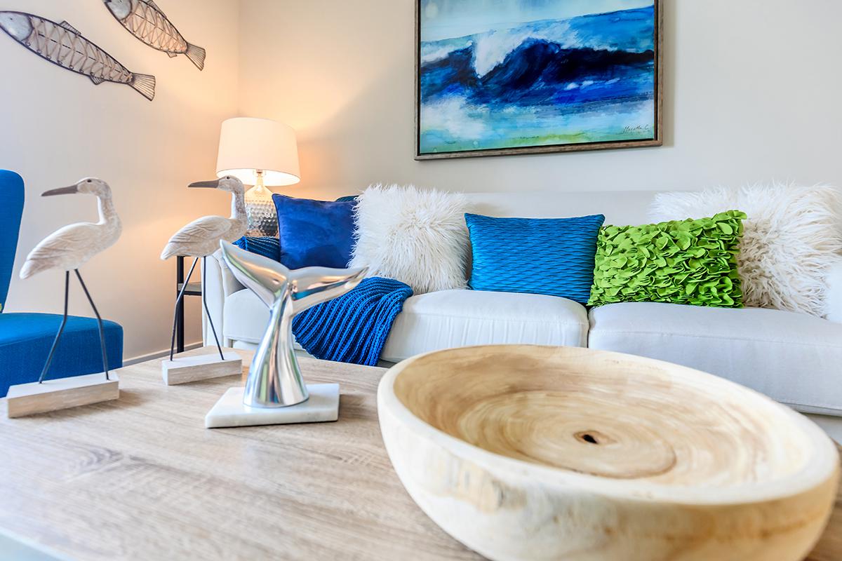 a living room filled with furniture and vase on a table