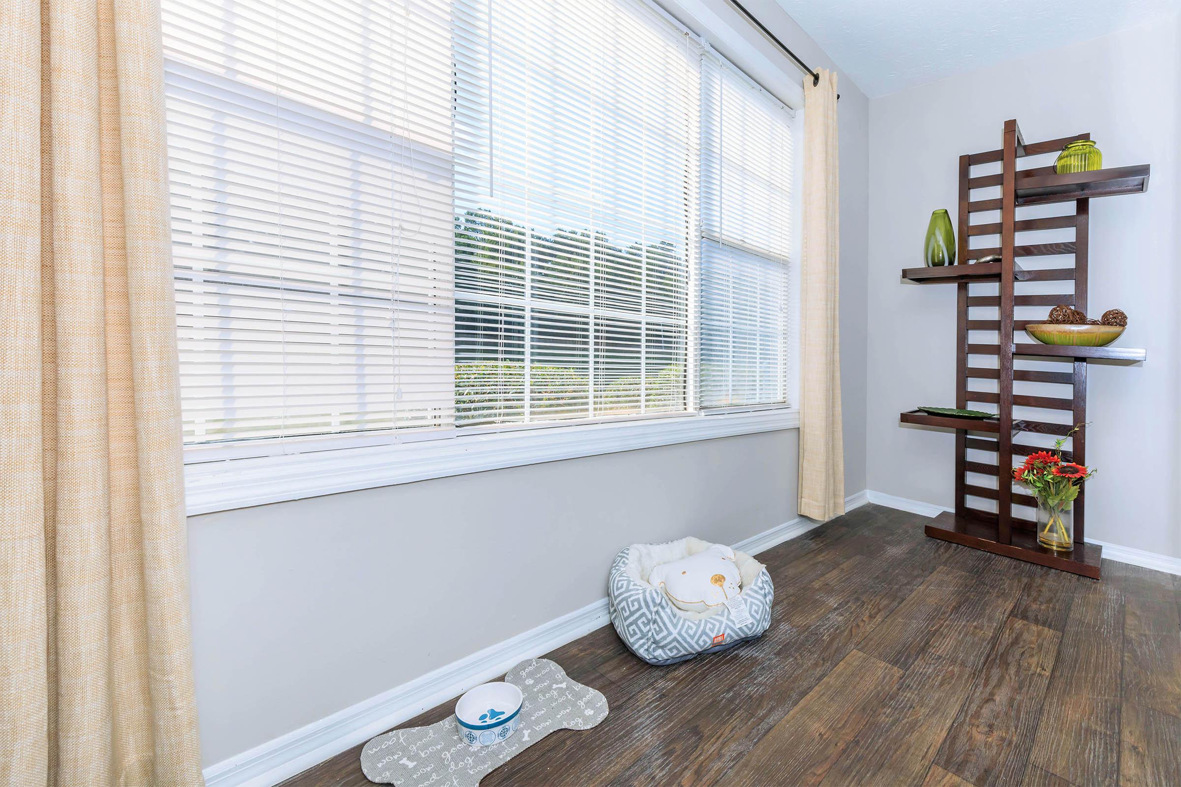 a bedroom with a large window