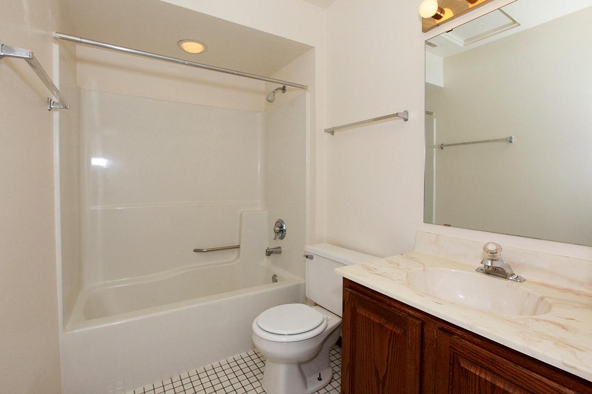 a white tub sitting next to a shower