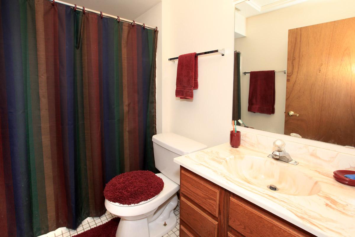 a red cabinet next to a sink