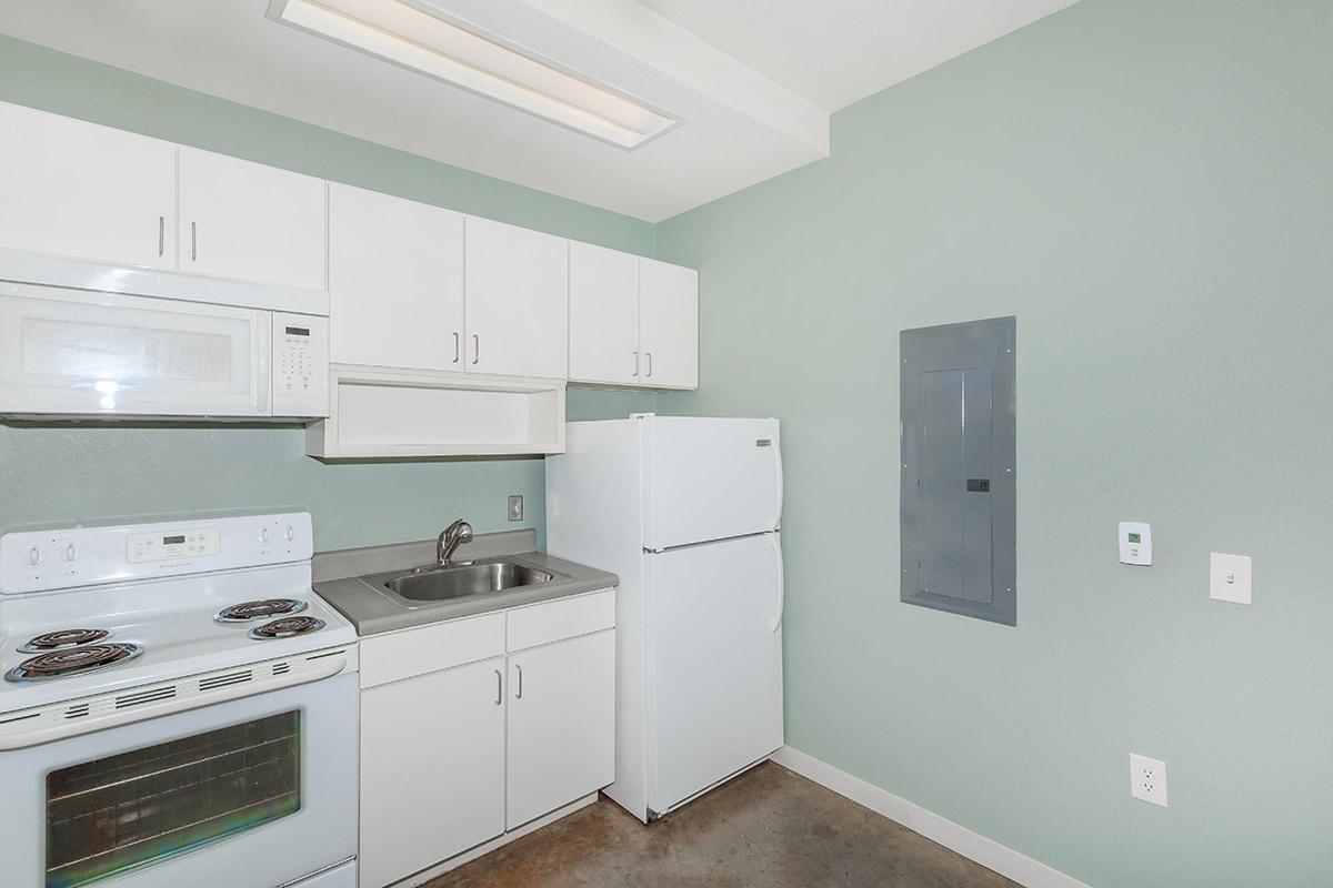 a kitchen with white cabinets and a sink