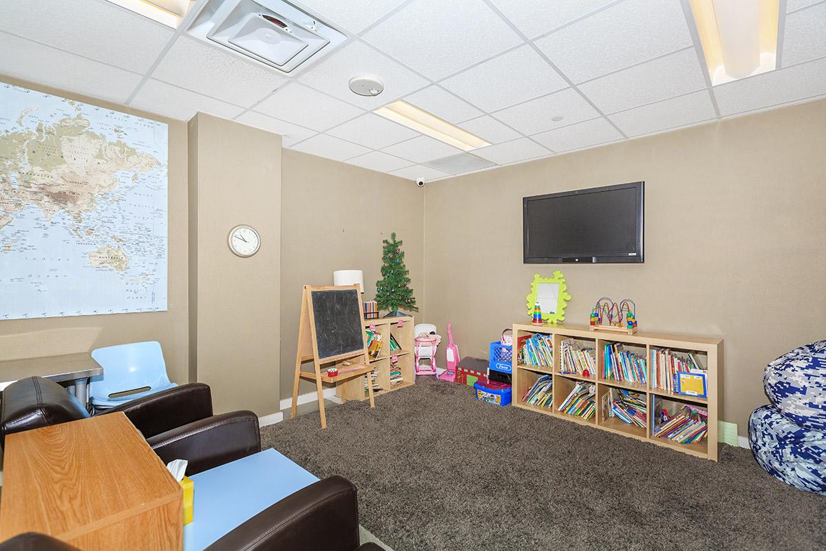 a living room filled with furniture and a tv