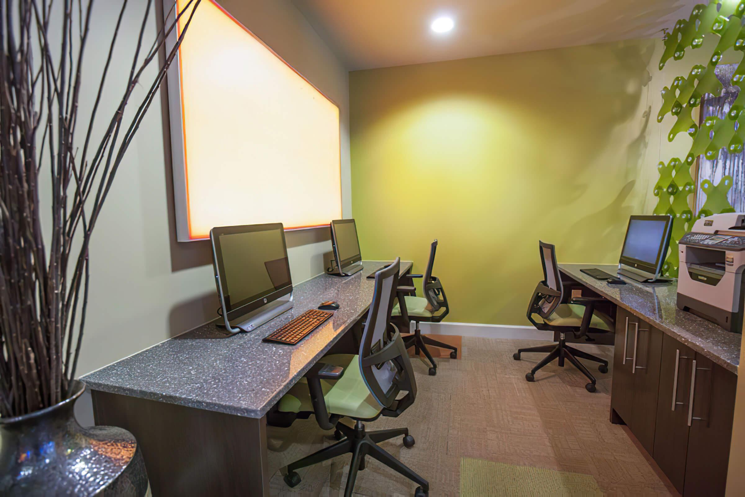 desks with computers and chairs