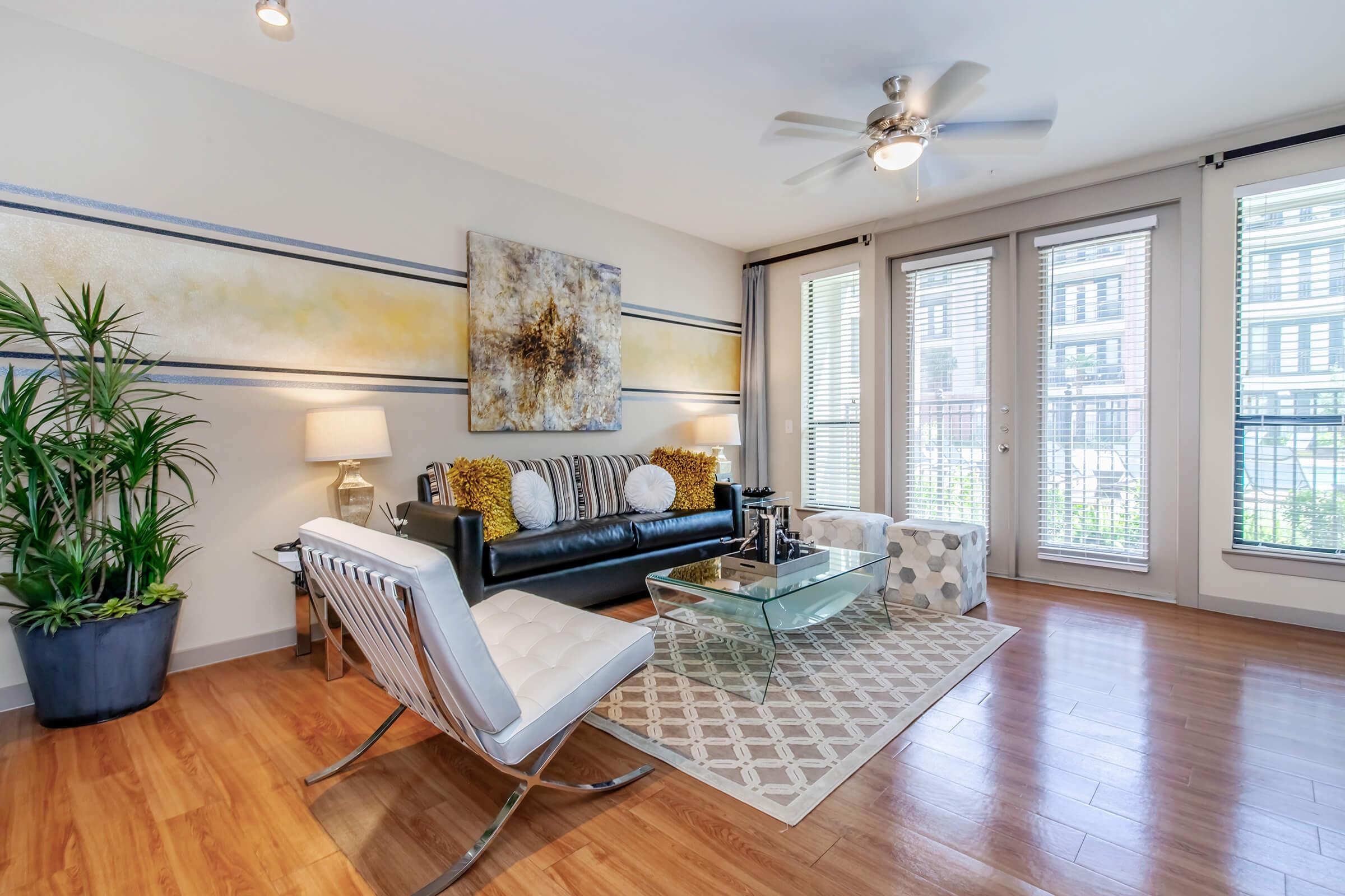 a living room filled with furniture and a large window