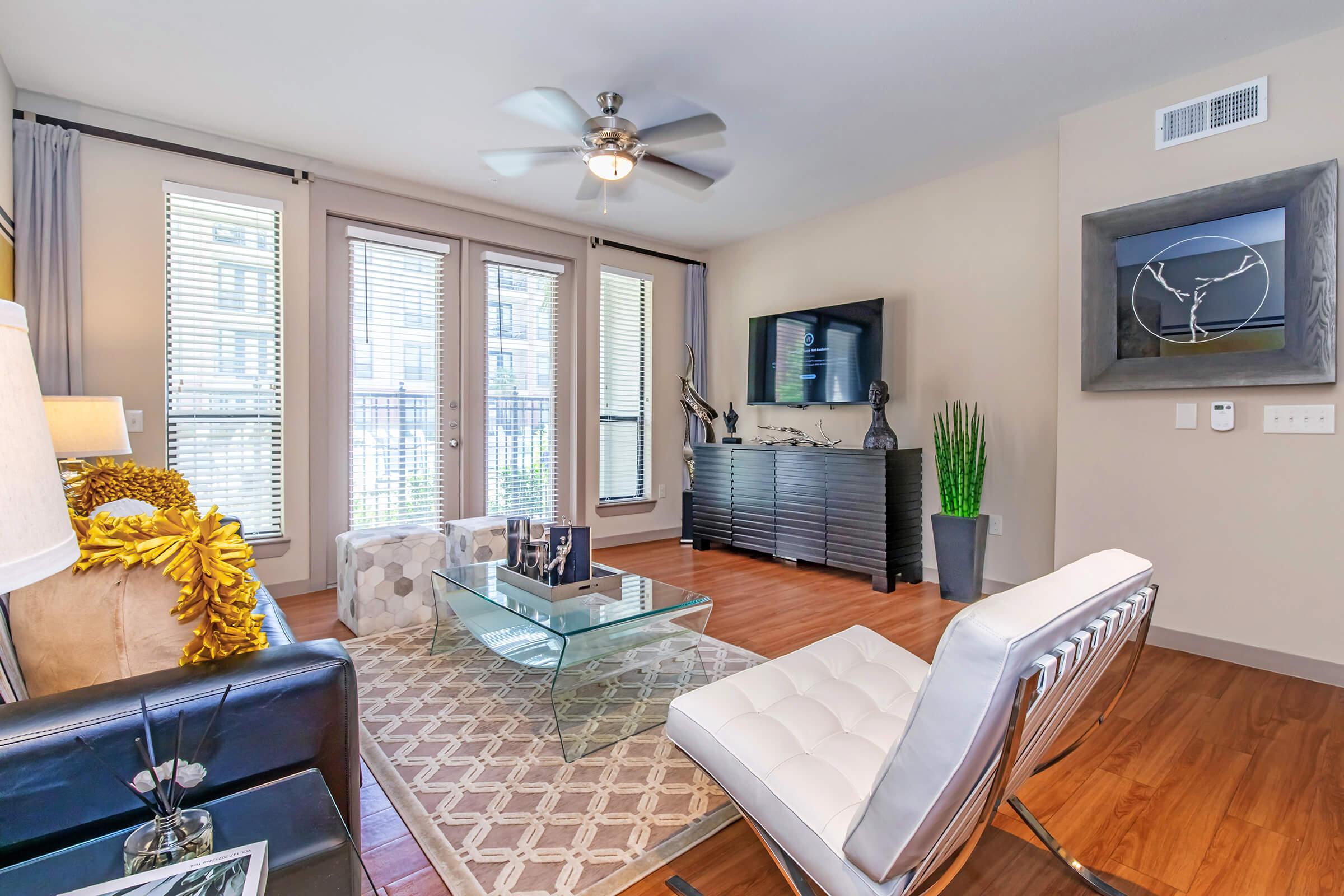 a living room filled with furniture and a large window