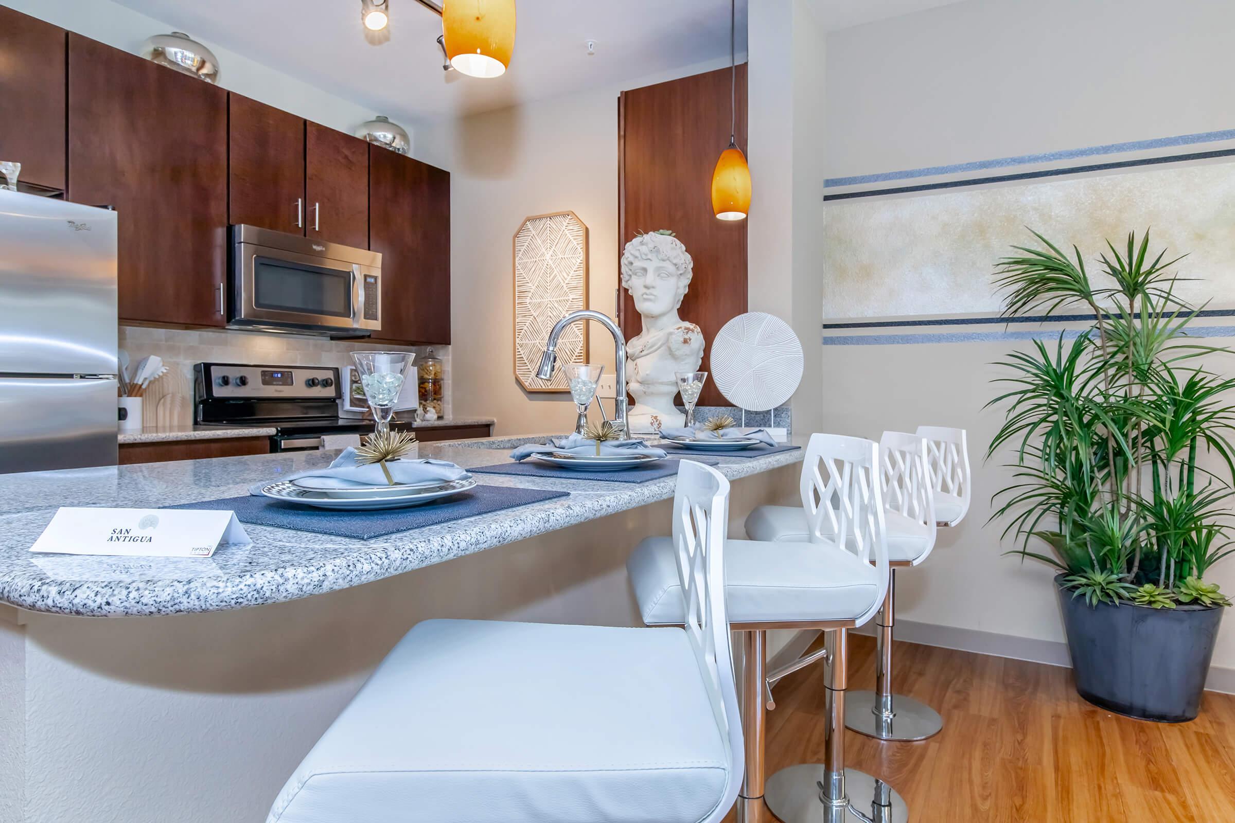 a kitchen with a table in front of a window