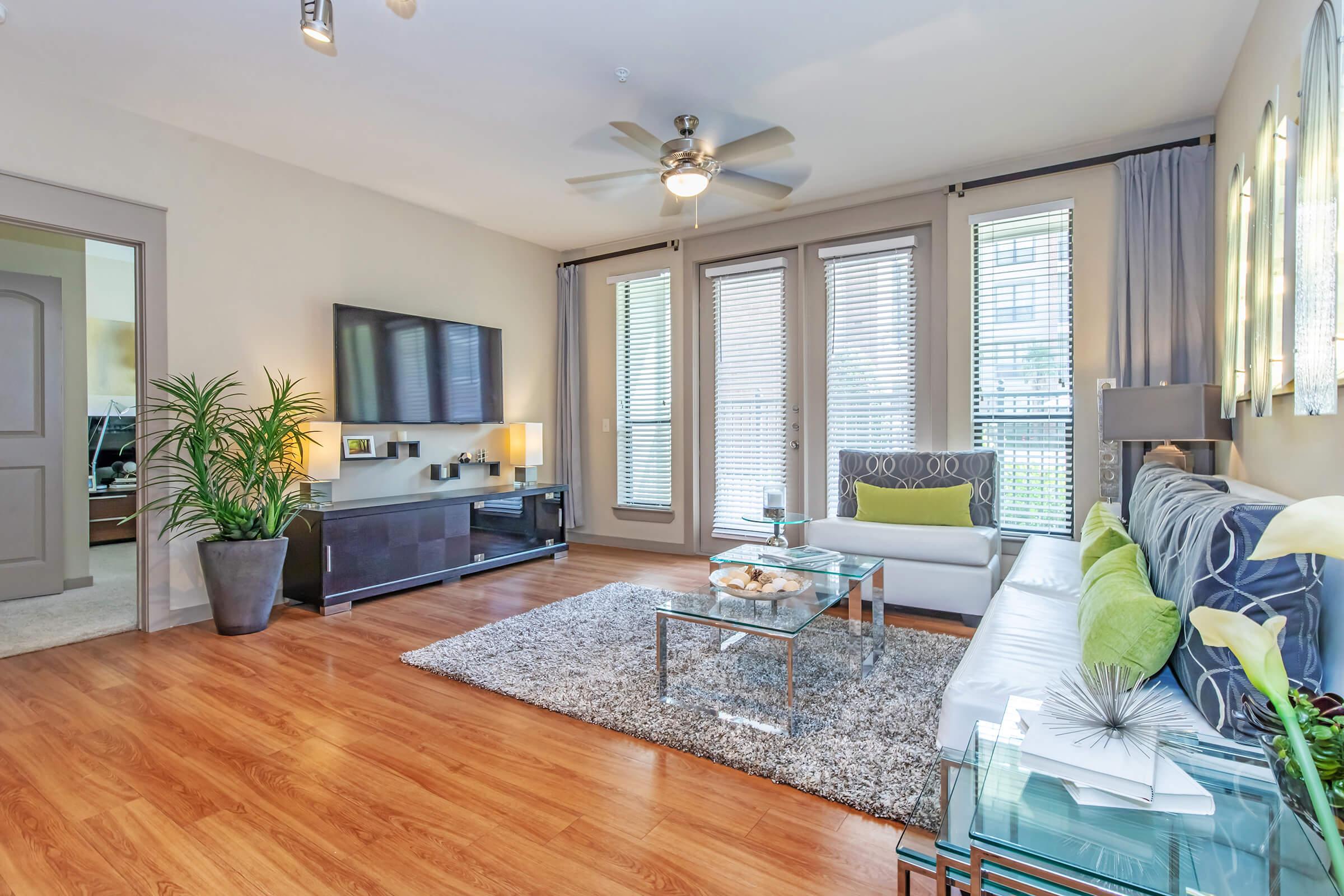 a living room filled with furniture and a large window