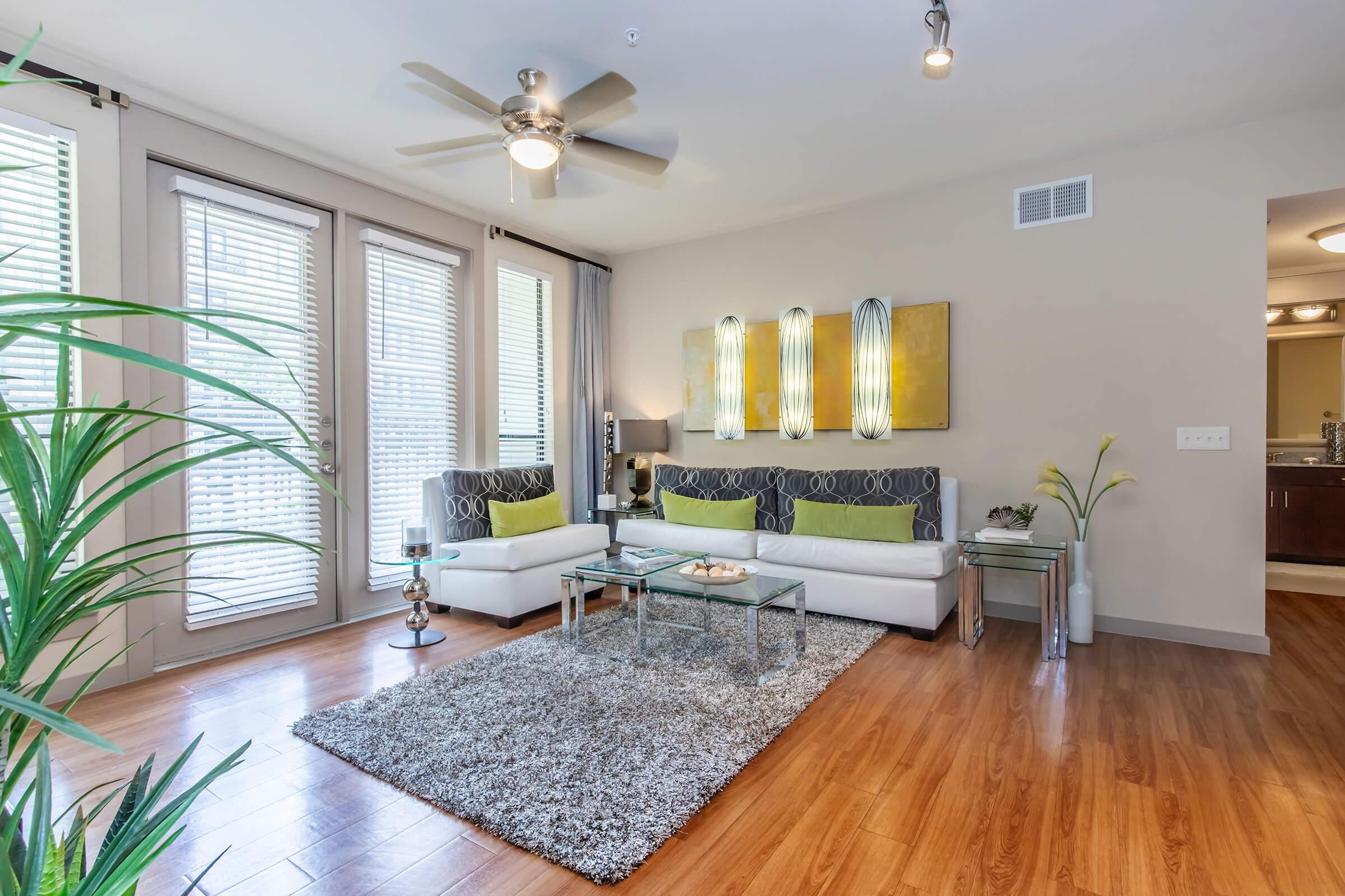 a living room filled with furniture and a large window