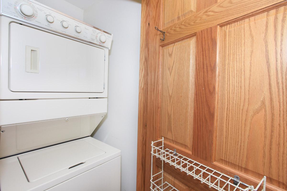 a white microwave oven sitting on top of a wooden door