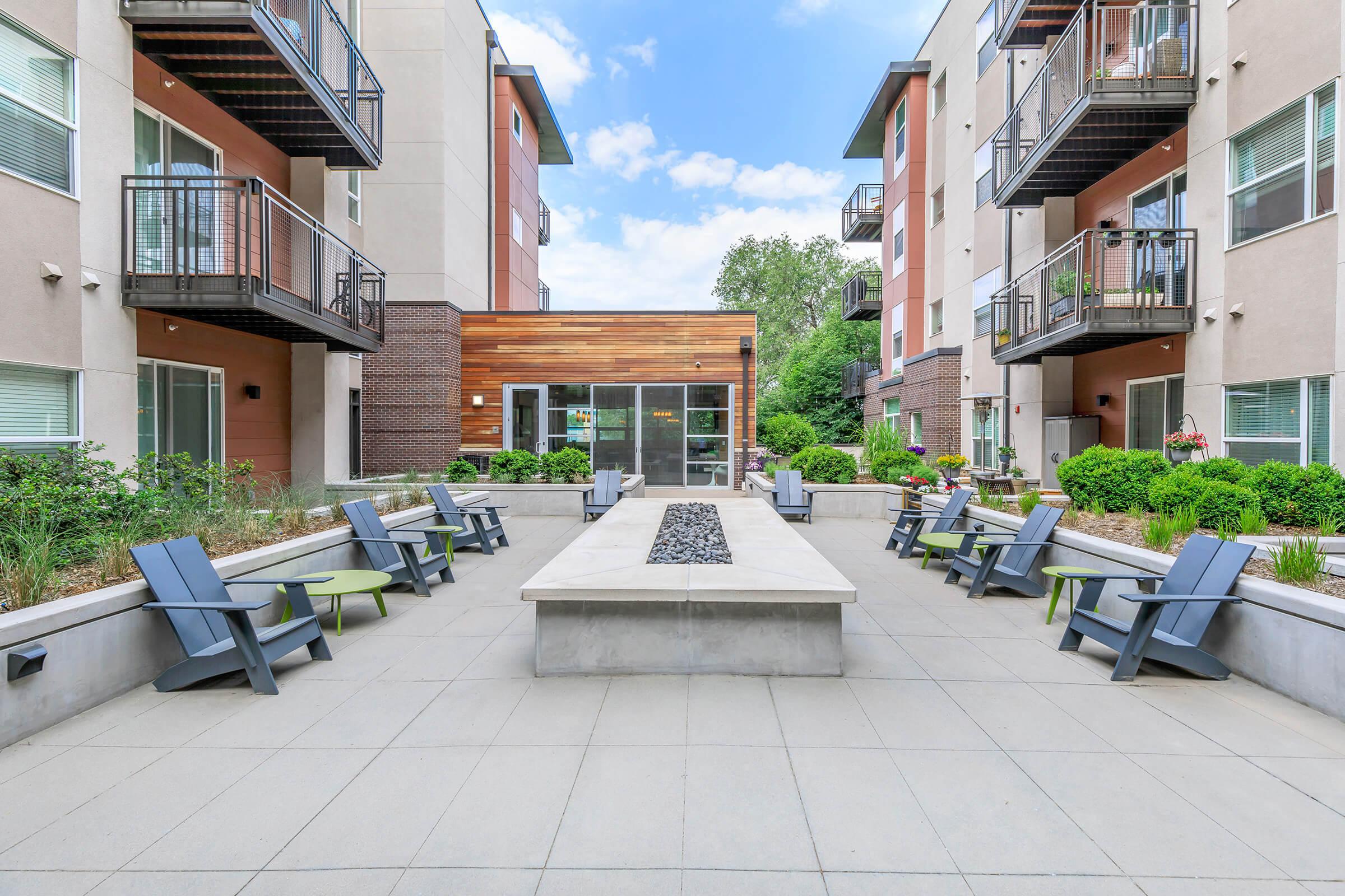 a bench in front of a brick building