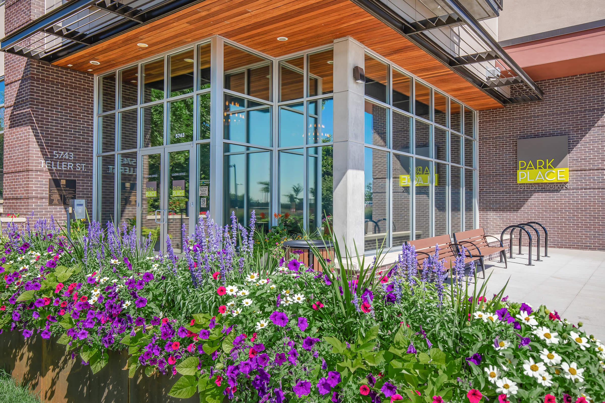 a colorful flower garden in front of a building