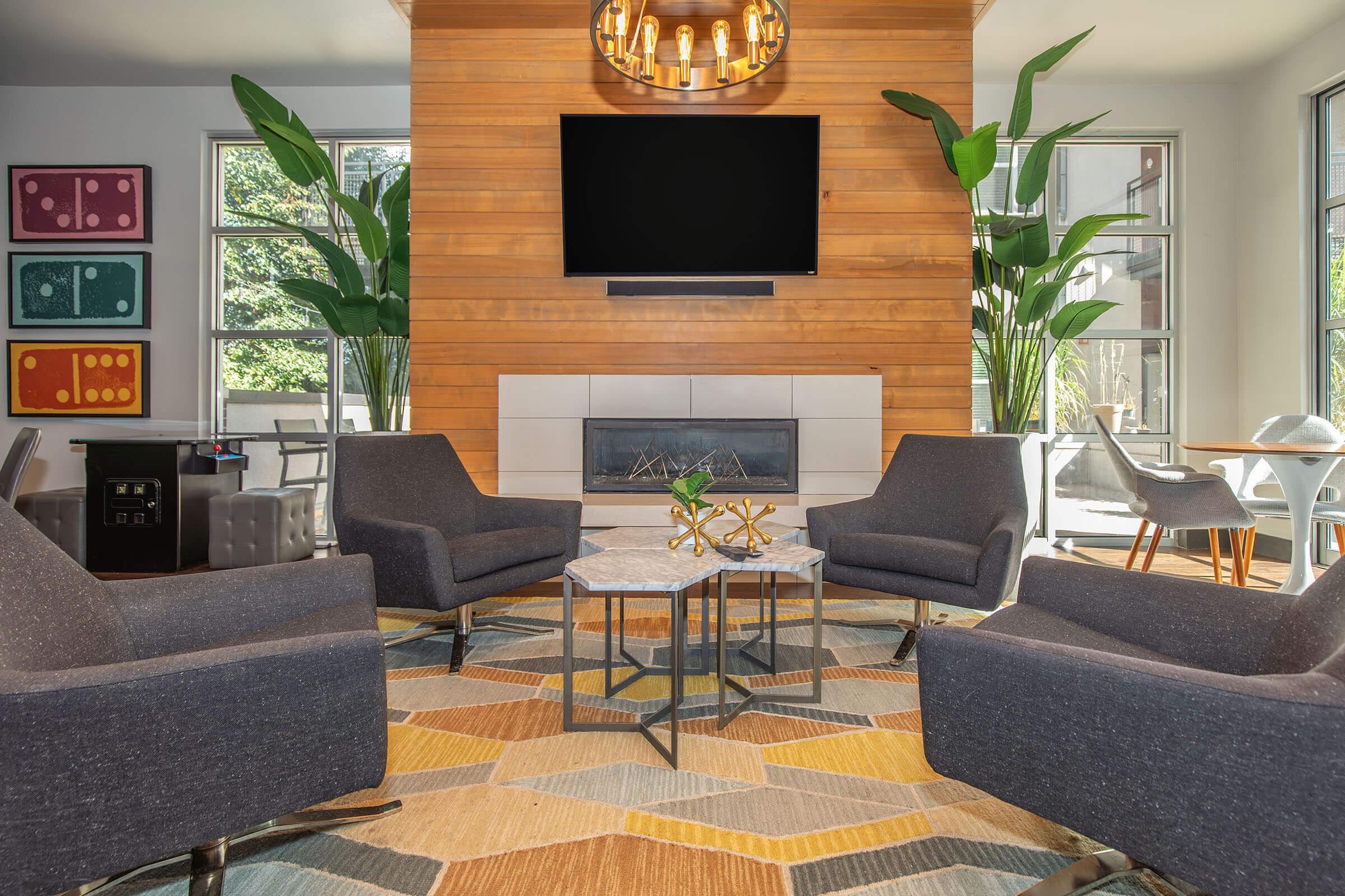 a living room filled with furniture and a flat screen tv