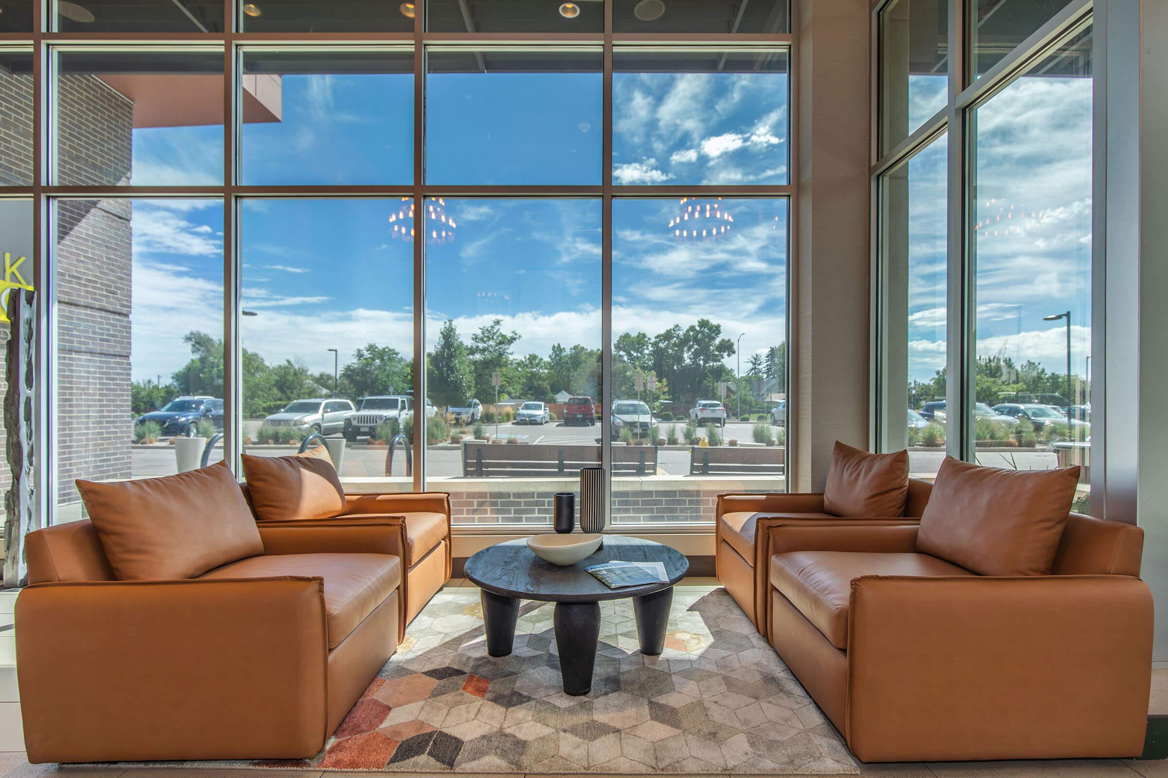 a view of a living room filled with furniture and a large window