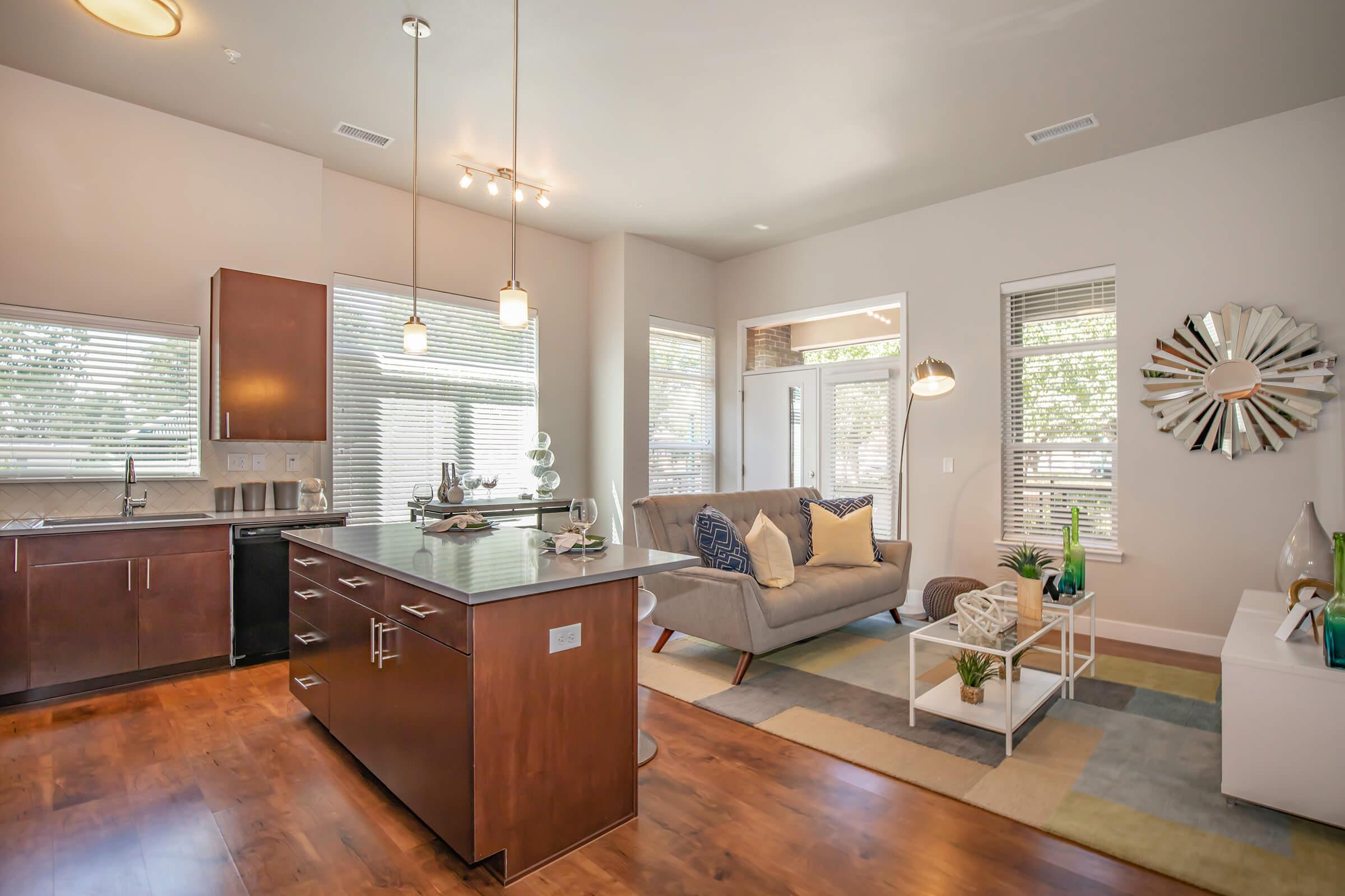 a living room filled with furniture on top of a hard wood floor