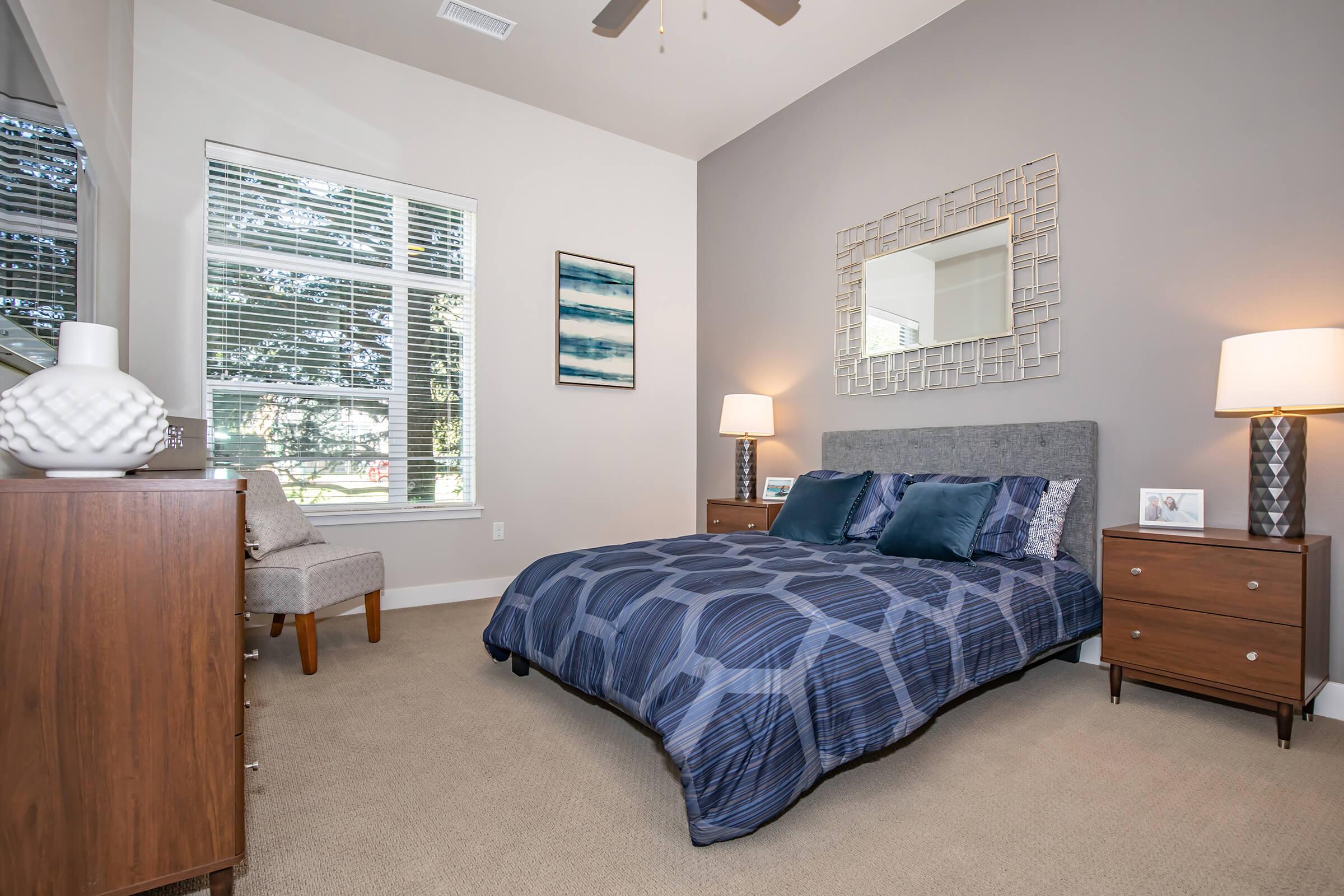 a bedroom with a bed and desk in a room