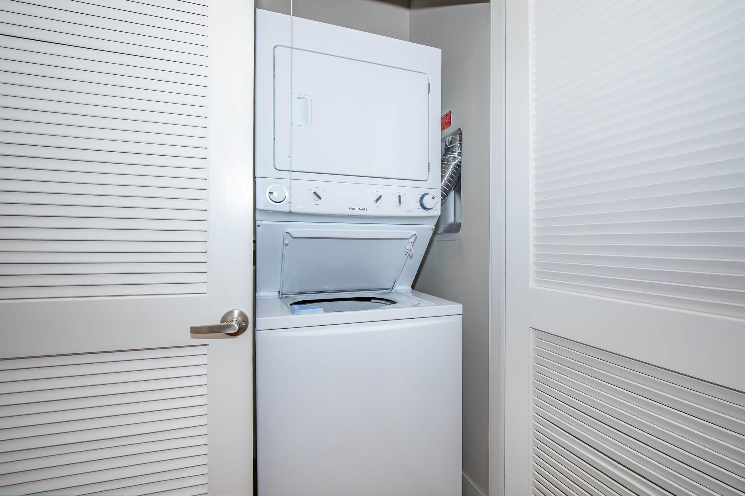 a white refrigerator freezer sitting next to a window