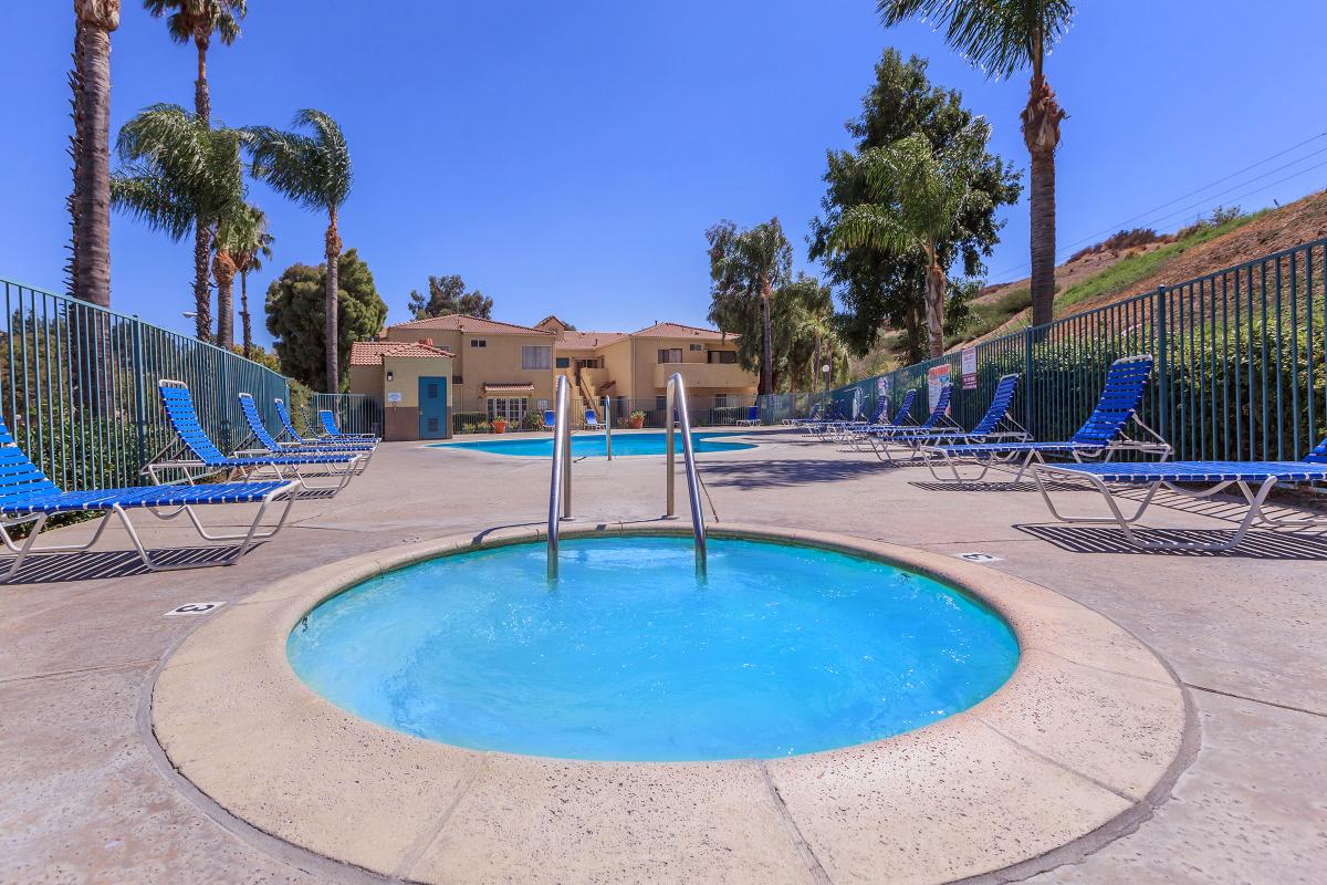 a group of palm trees next to a swimming pool