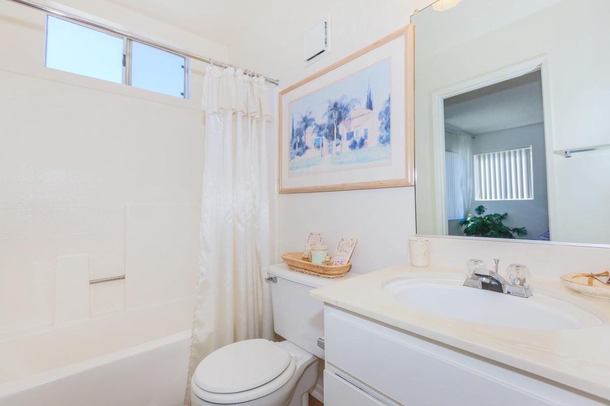 a large white tub next to a sink