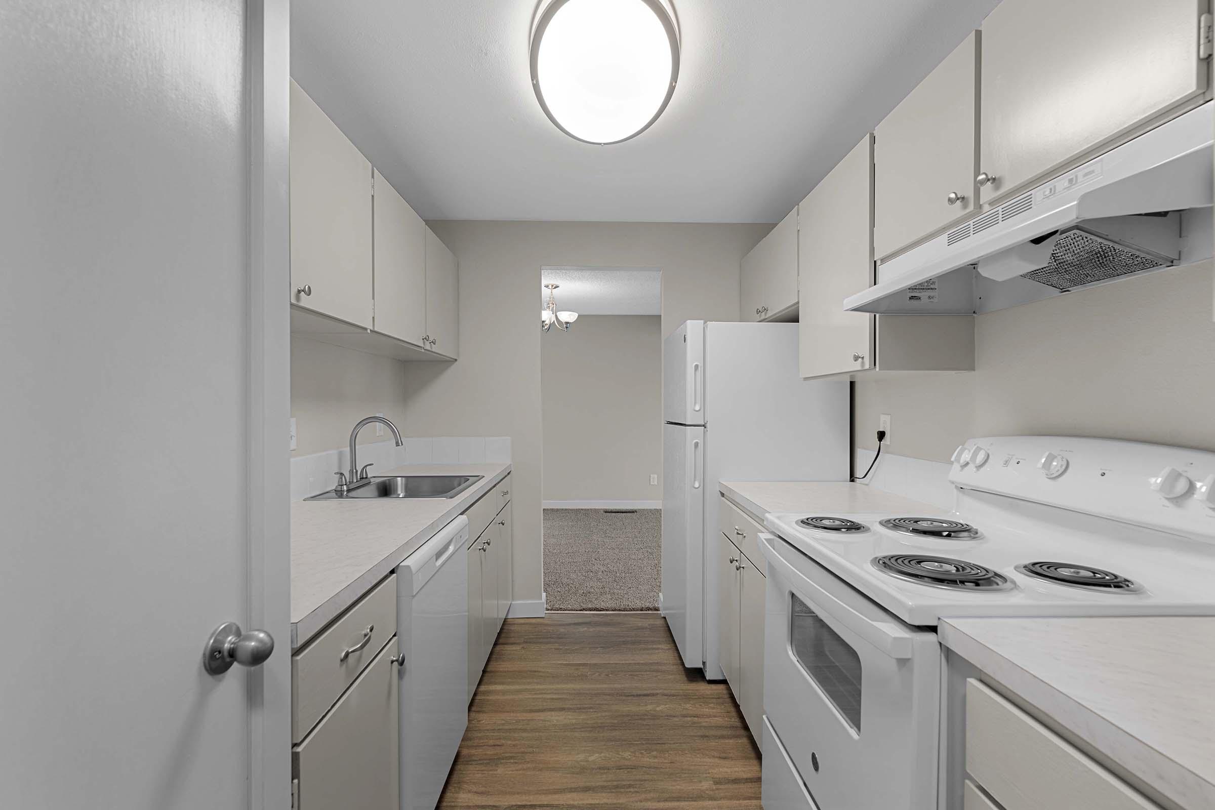 a kitchen with a sink and a mirror