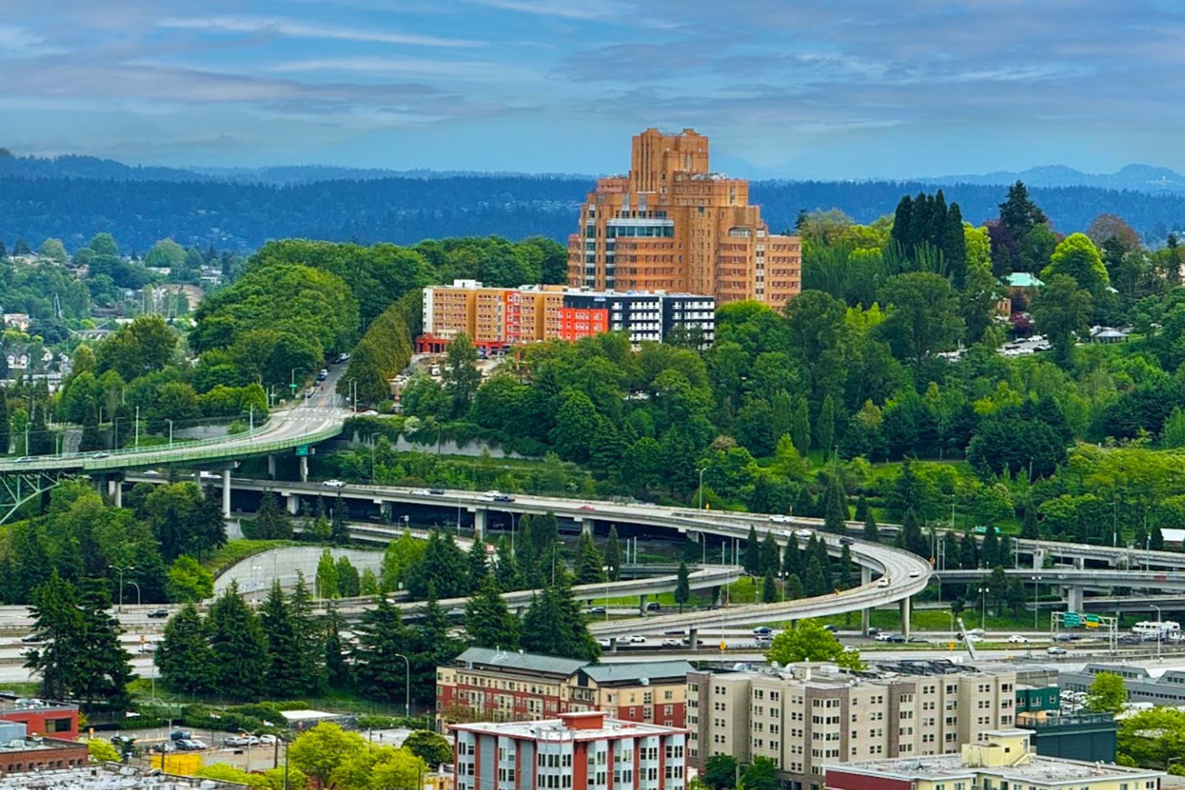 a train crossing a bridge over a river in a city