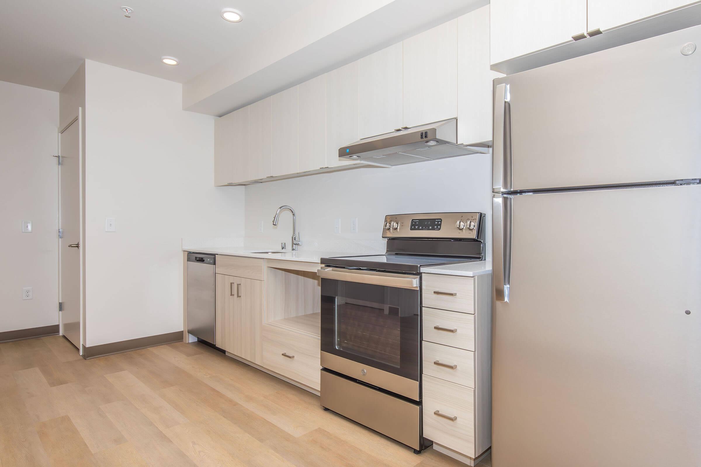 a kitchen with a stove and a refrigerator