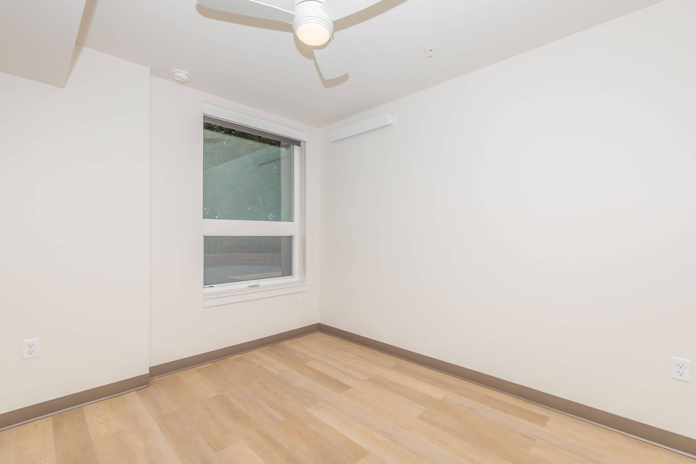 a bedroom with a wooden floor