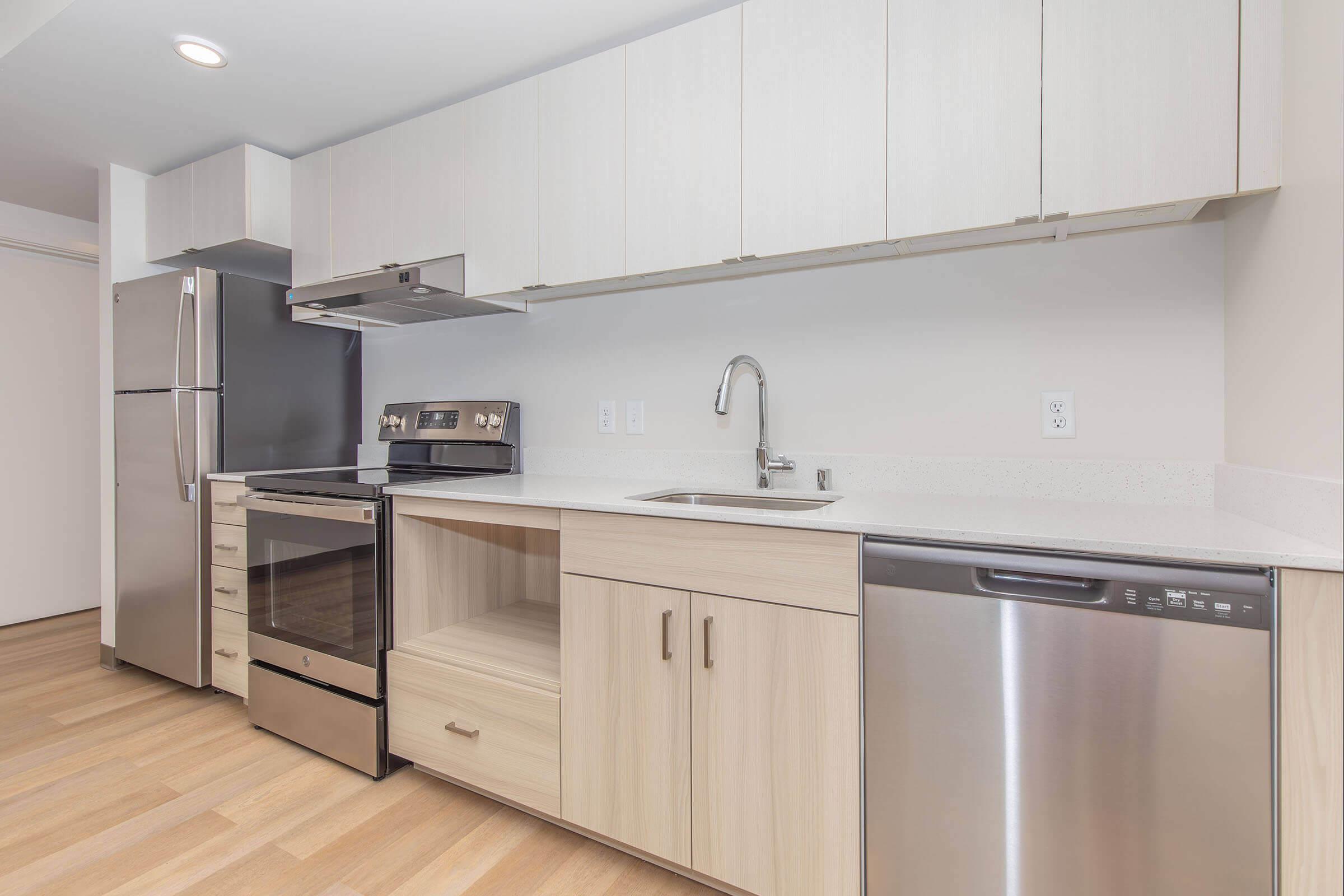 a kitchen with stainless steel appliances and wooden cabinets