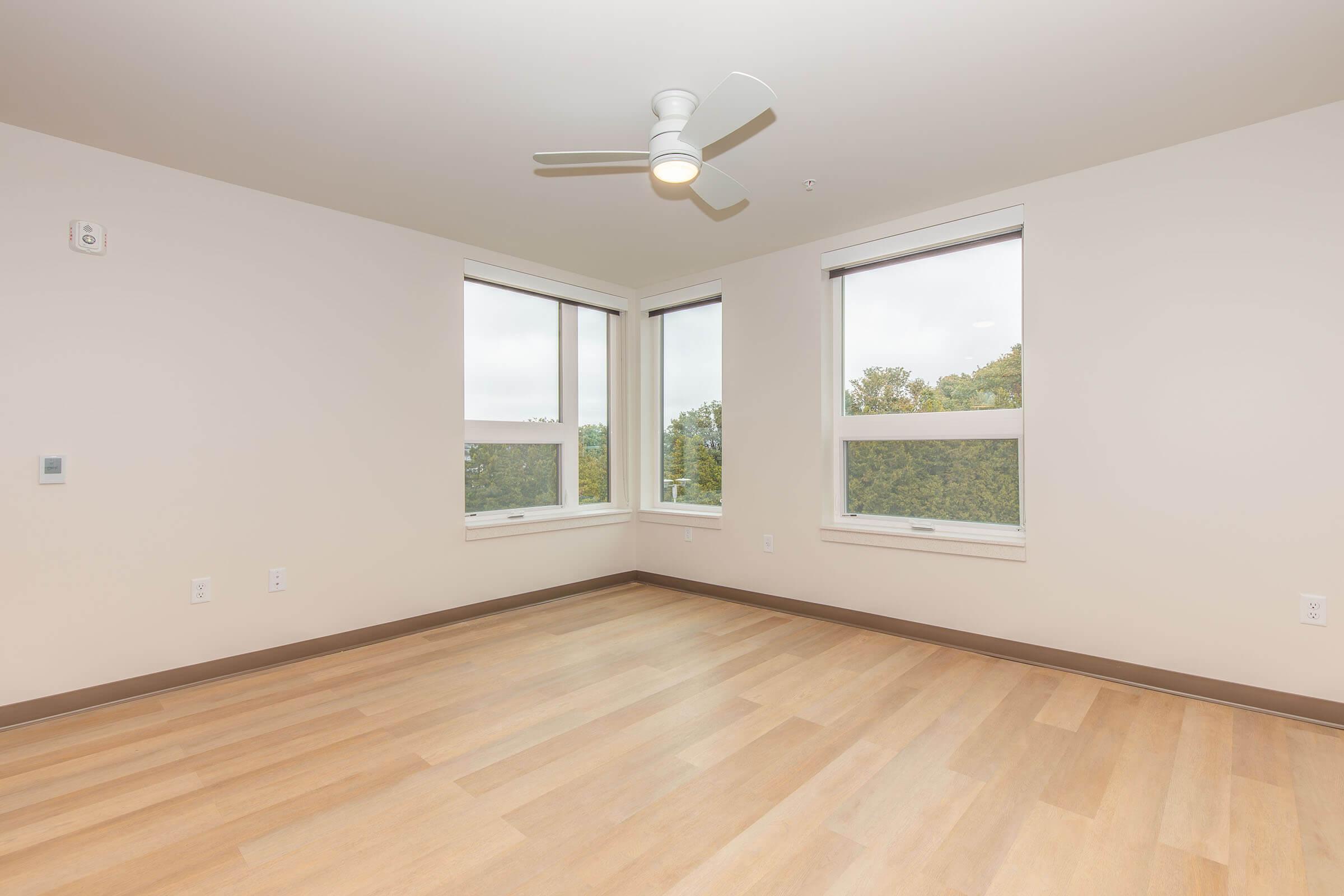 a close up of a hard wood floor next to a window