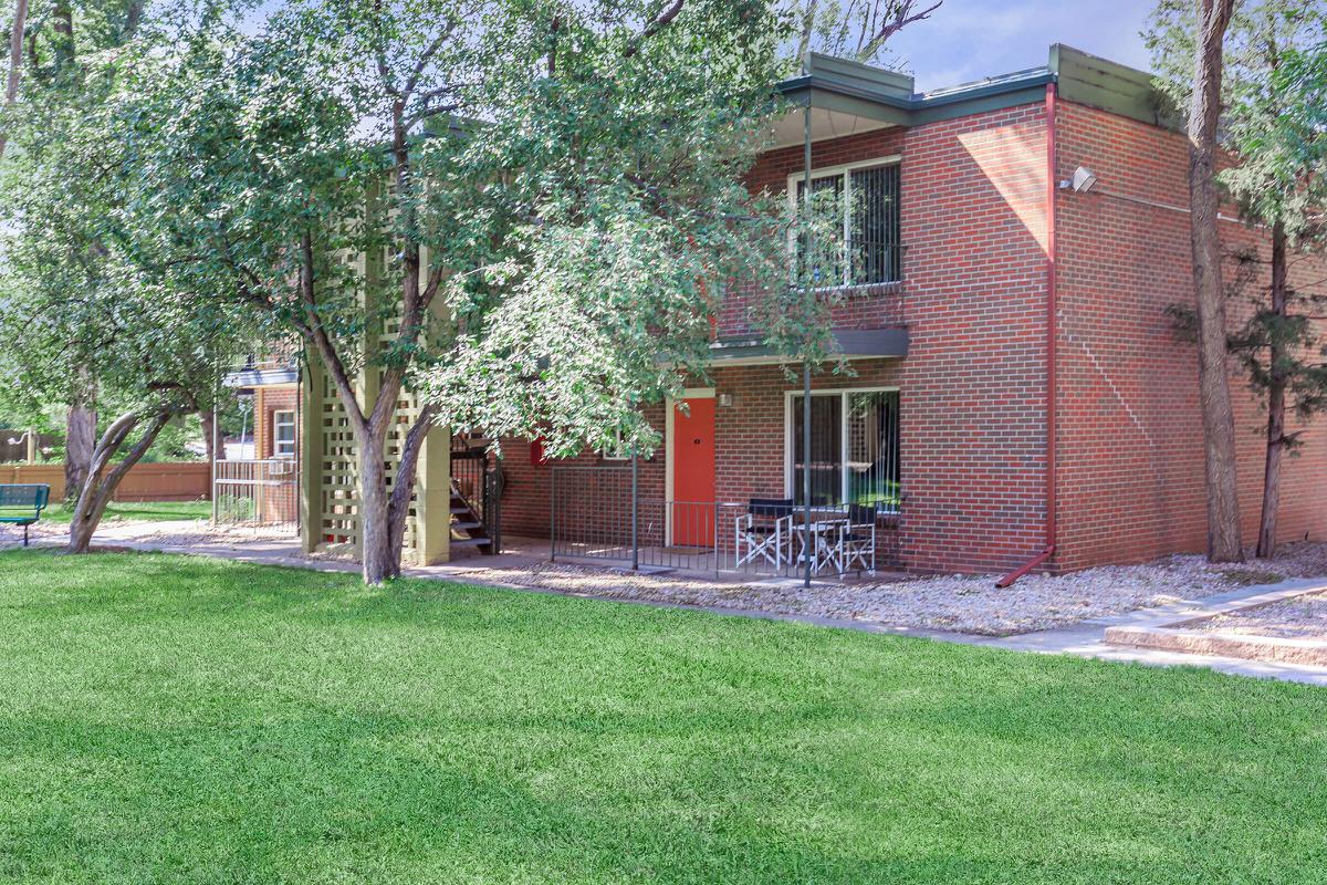 a large lawn in front of a brick building