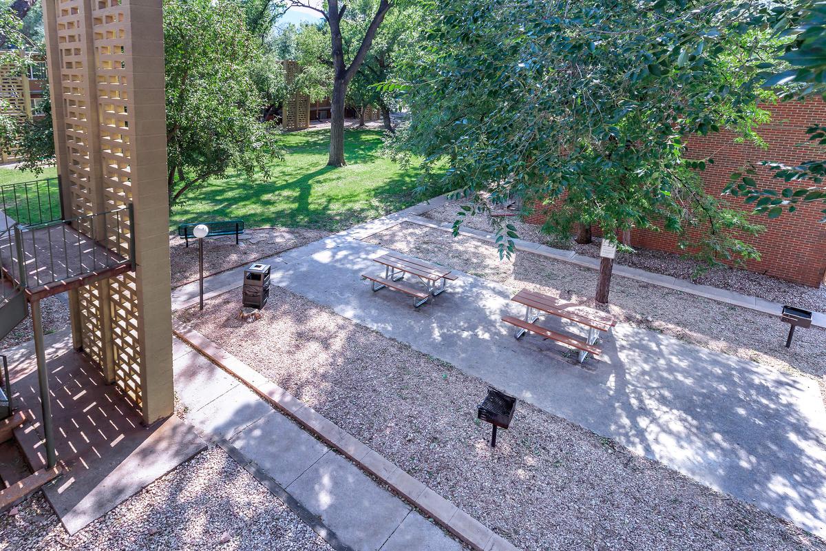 an empty park bench next to a pool