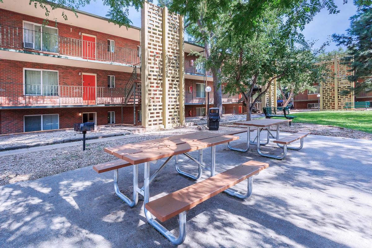 a bench in front of a brick building